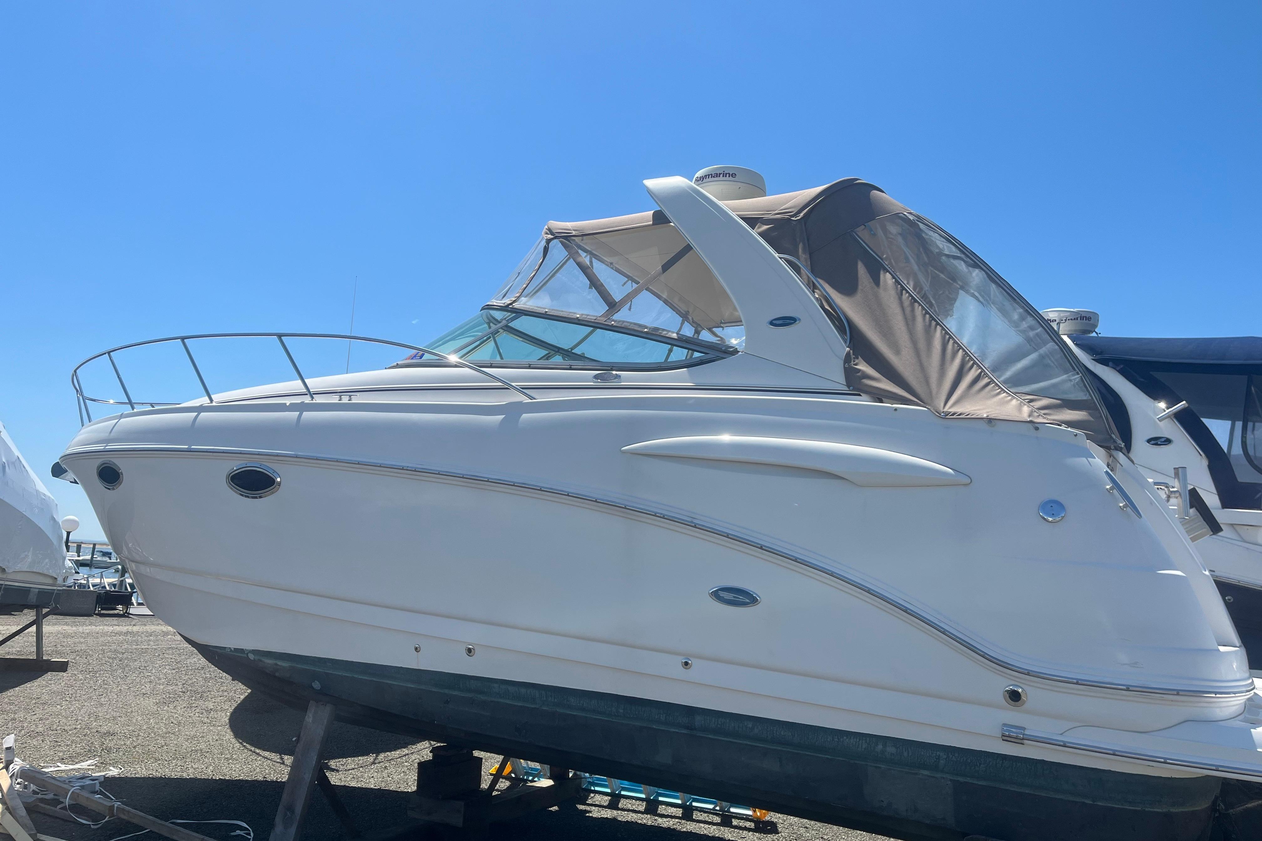 2005 CHAPPARAL 290 SIGNATURE boat with canopy, displayed outdoors under clear blue sky.