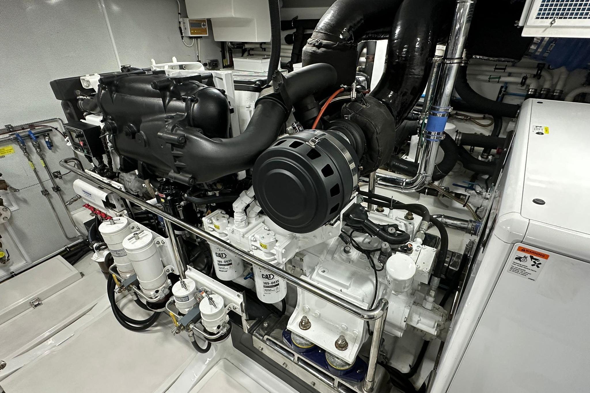Engine room of 2023 Marlow Explorer 66E-CB yacht, showcasing advanced machinery and components.