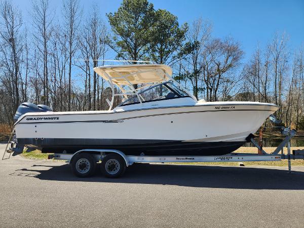 2015 Grady-White Freedom 275 boat on trailer, parked outdoors.