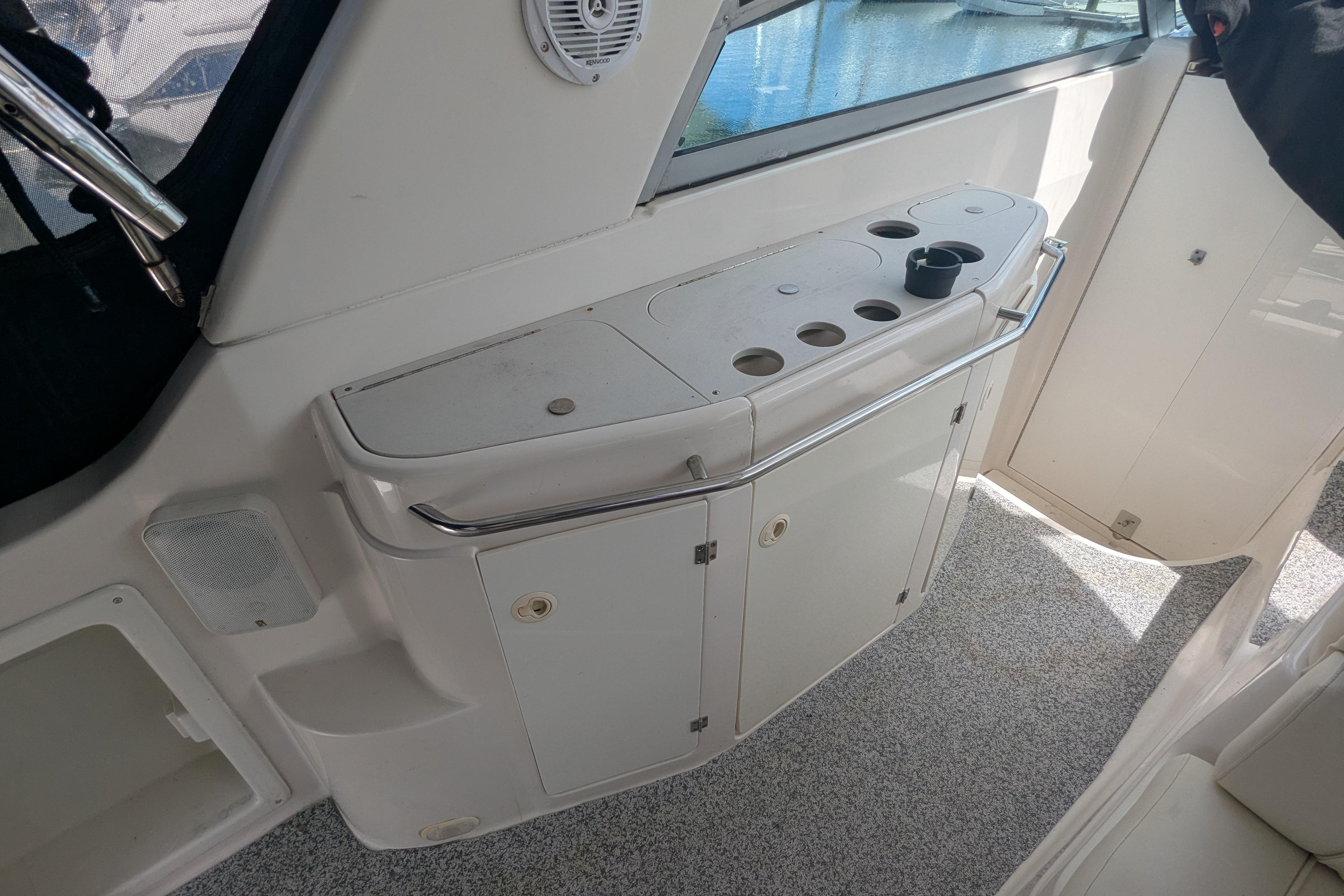 2003 Monterey 282 Cruiser interior with storage cabinets and cup holders.