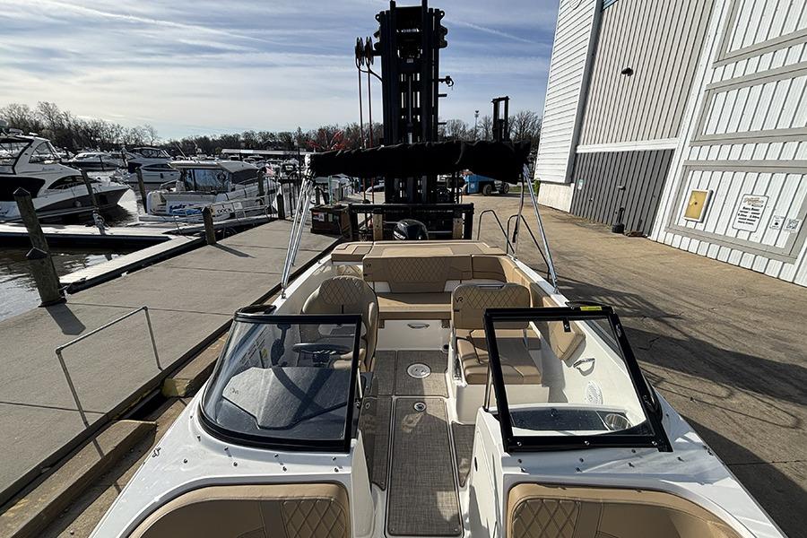 2023 Bayliner VR5 Bowrider OB docked at marina, showcasing spacious interior and sleek design.