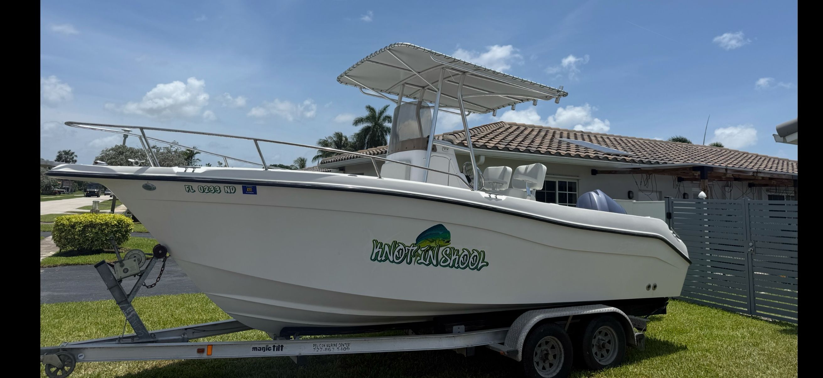 2006 Seaswirl Striper Center Console boat on trailer, sunny day.