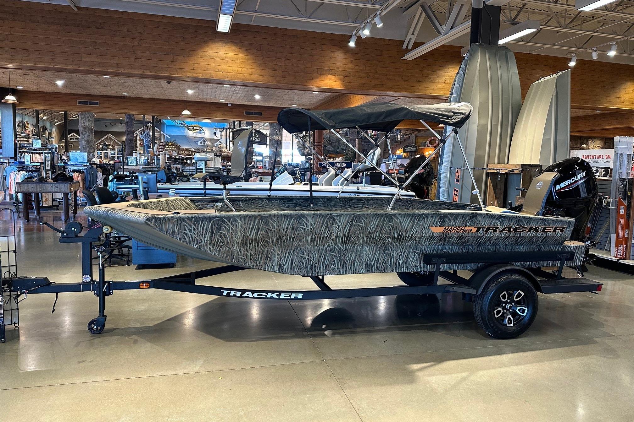 2026 Tracker Grizzly 1756 T Marsh boat displayed indoors on a trailer.