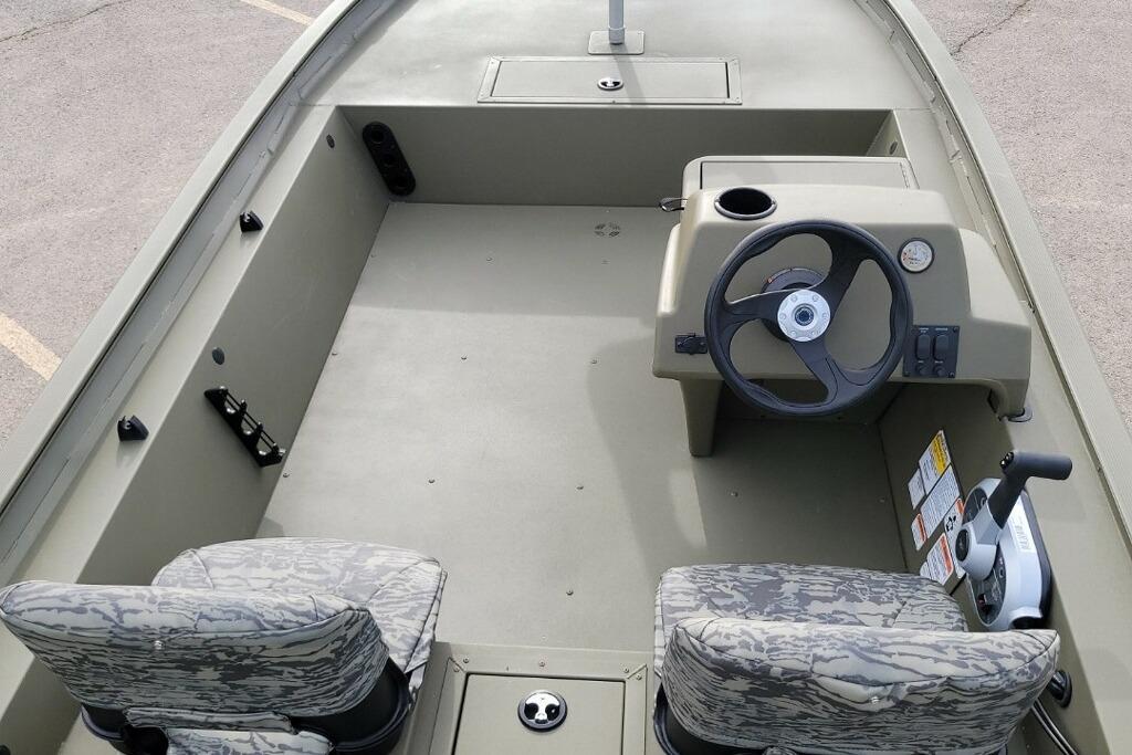 2026 Tracker Grizzly 1754 SC boat interior with steering console and camo seats.