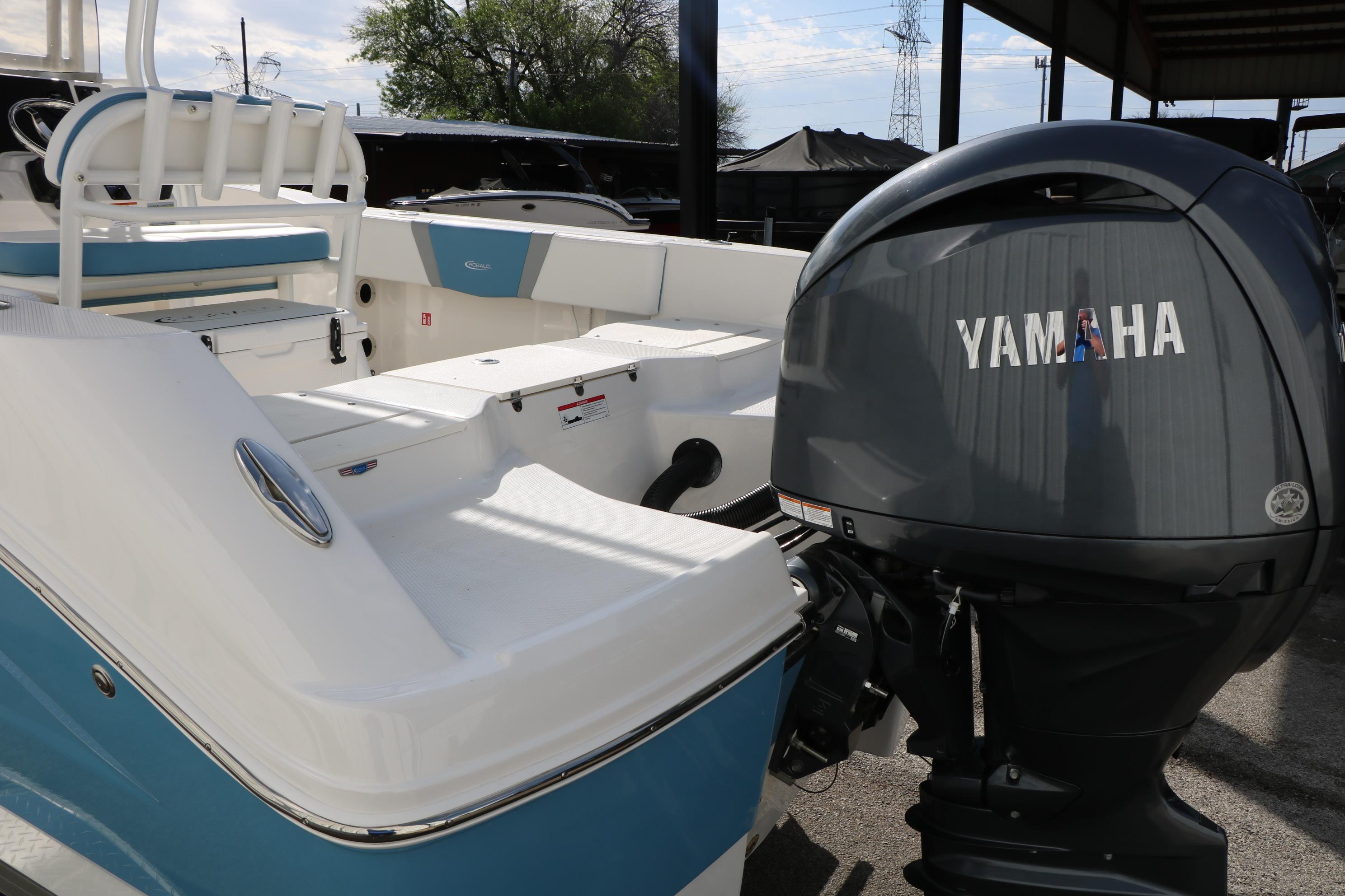 2026 Robalo R200 Center Console boat with Yamaha outboard motor, docked outdoors.