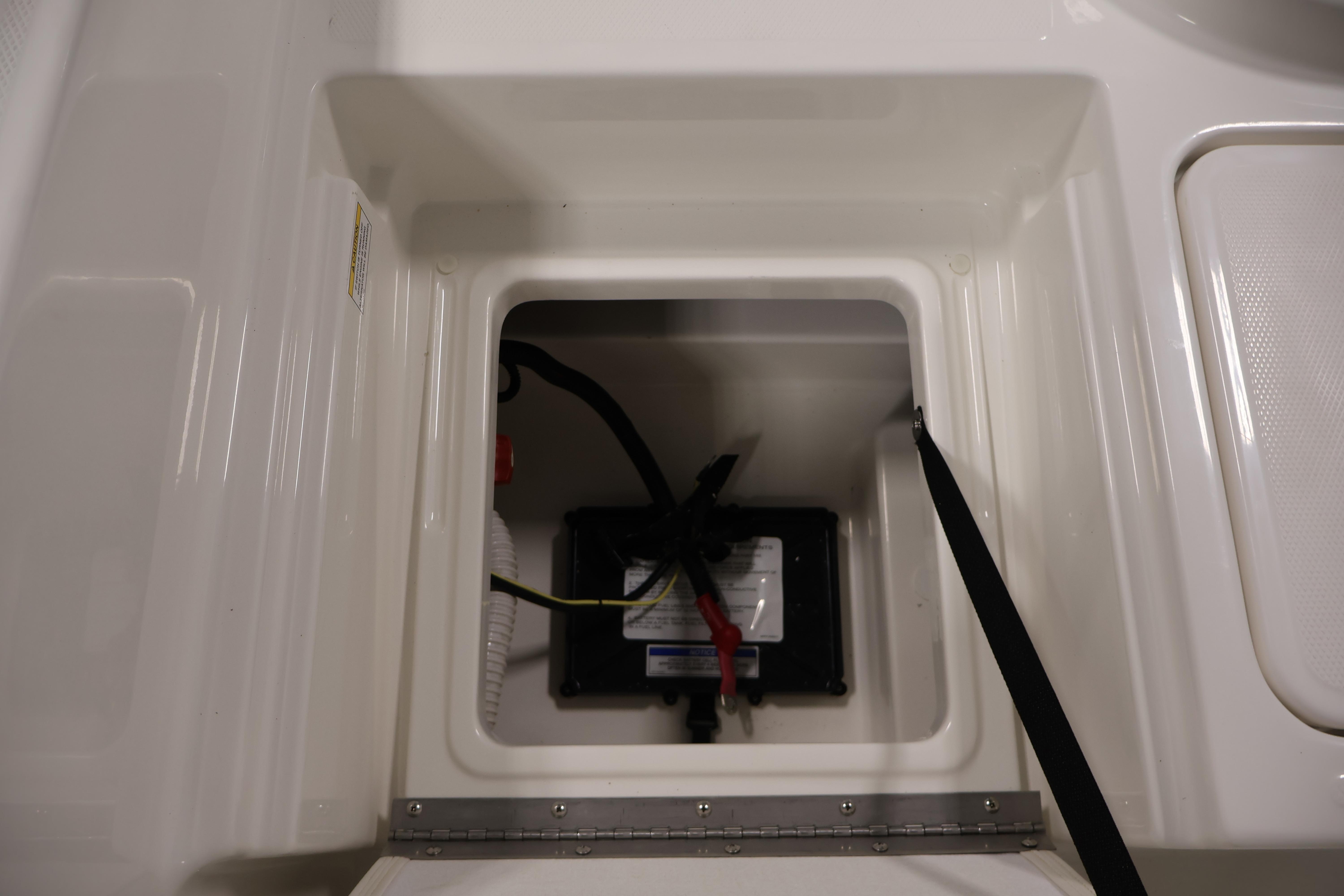 Battery compartment of 2026 Bayliner Trophy T18 boat, featuring secure wiring and storage.
