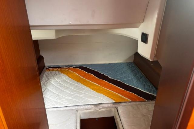 Interior cabin of 2013 Beneteau Gran Turismo 38 with colorful bedding.