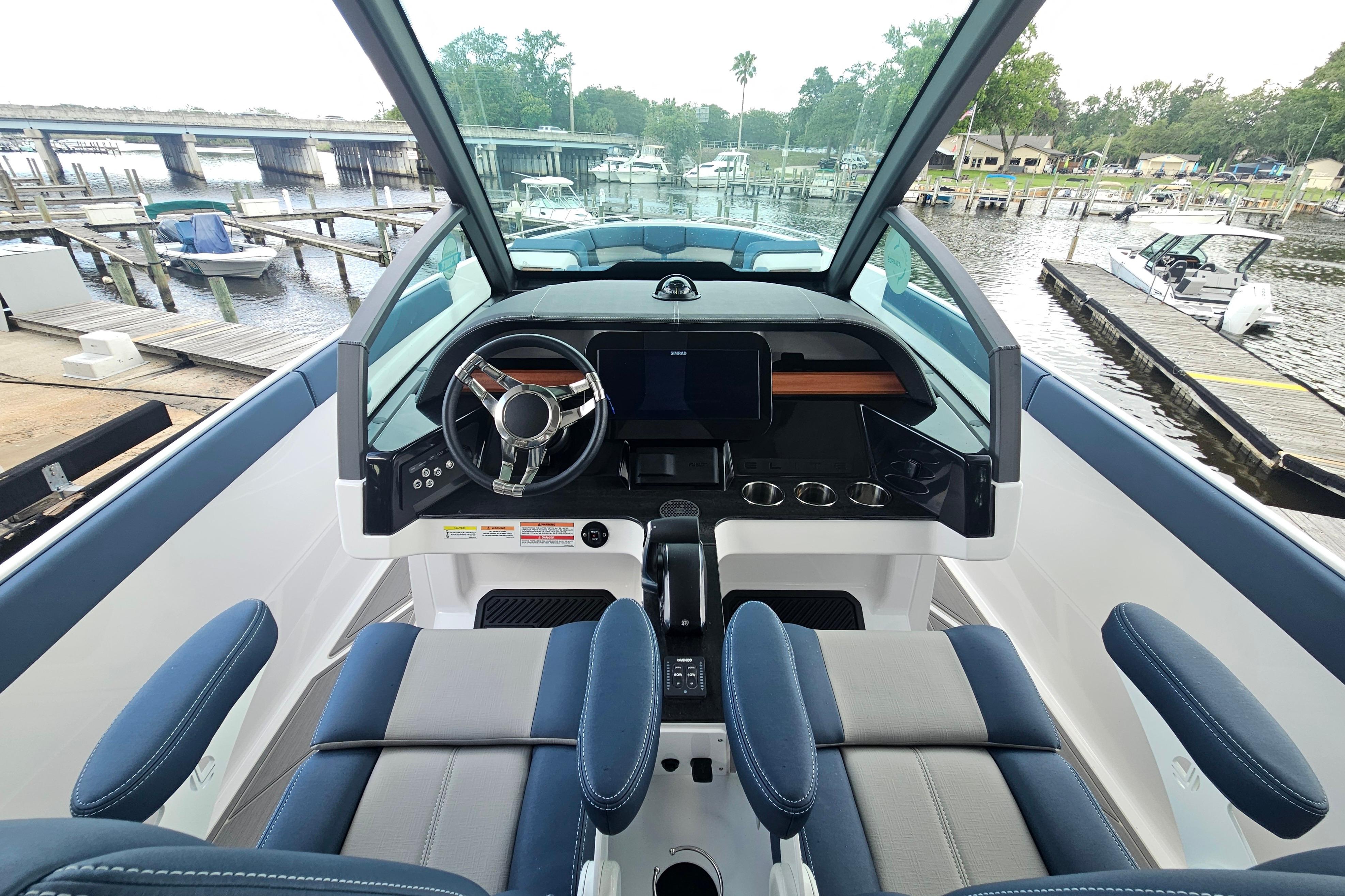 Interior view of 2026 Monterey Elite 27 OB boat, featuring modern helm and seating.