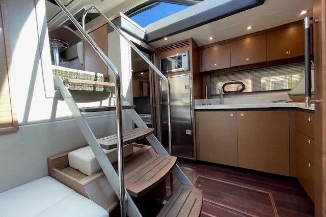 Luxurious interior of 2016 Sea Ray Sundancer 510 yacht with modern kitchen and staircase.