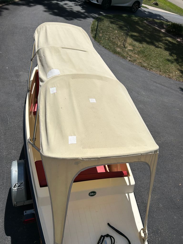 1995 Elco Launchboat with beige canopy on trailer.