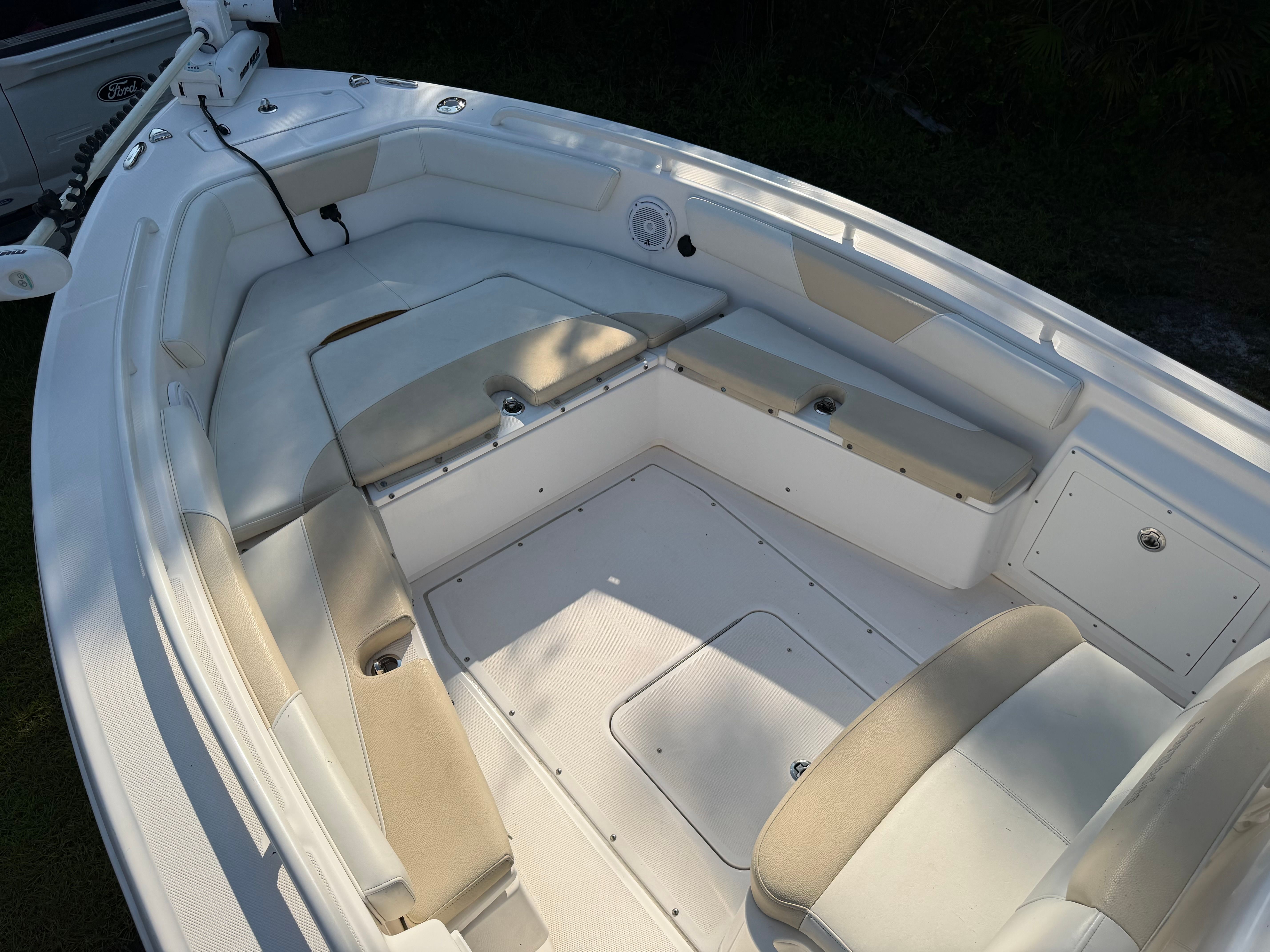 The image shows the bow of a 2016 Everglades 243 Center Console boat with seating.