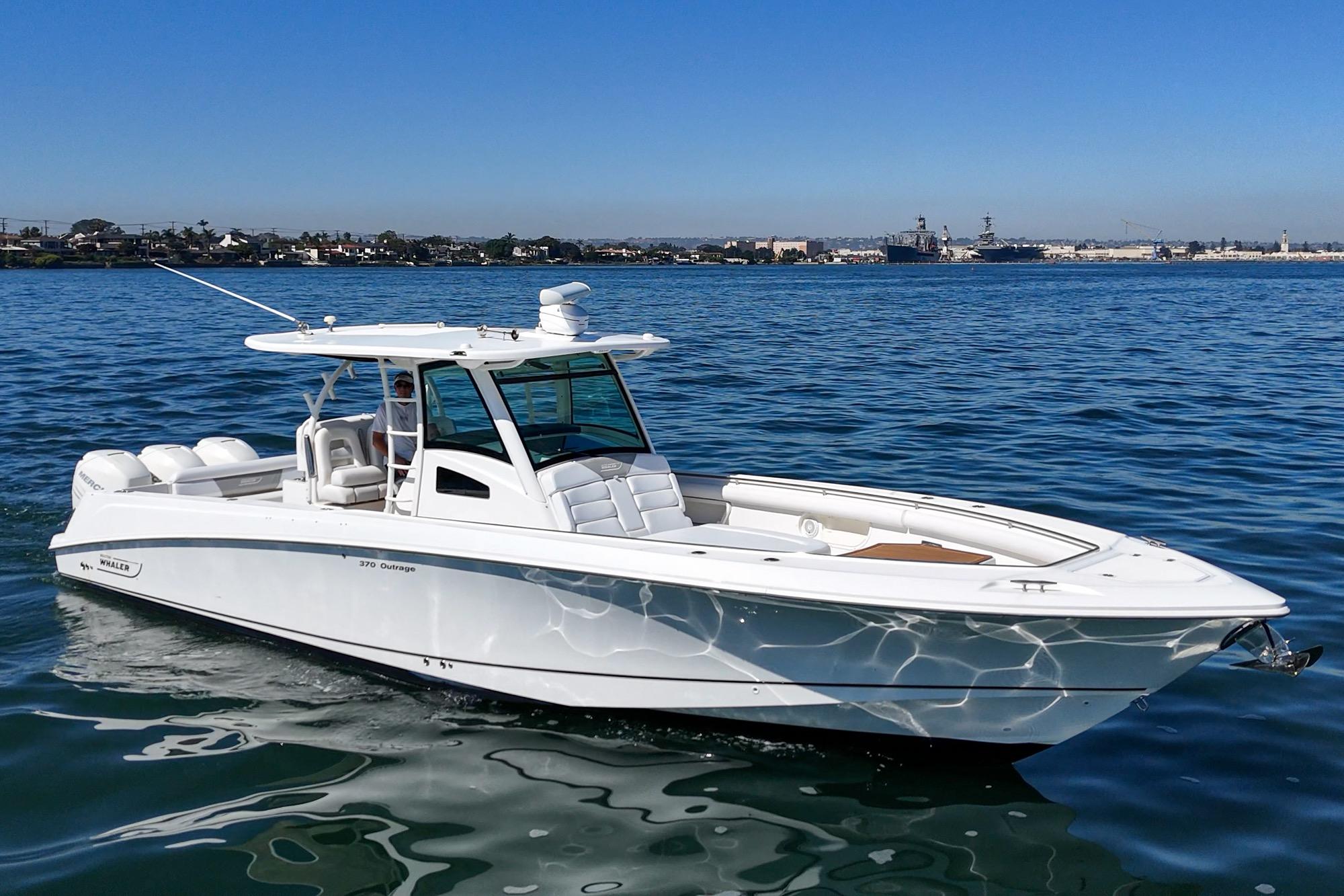 2015 Boston Whaler 370 Outrage boat cruising on calm blue waters.