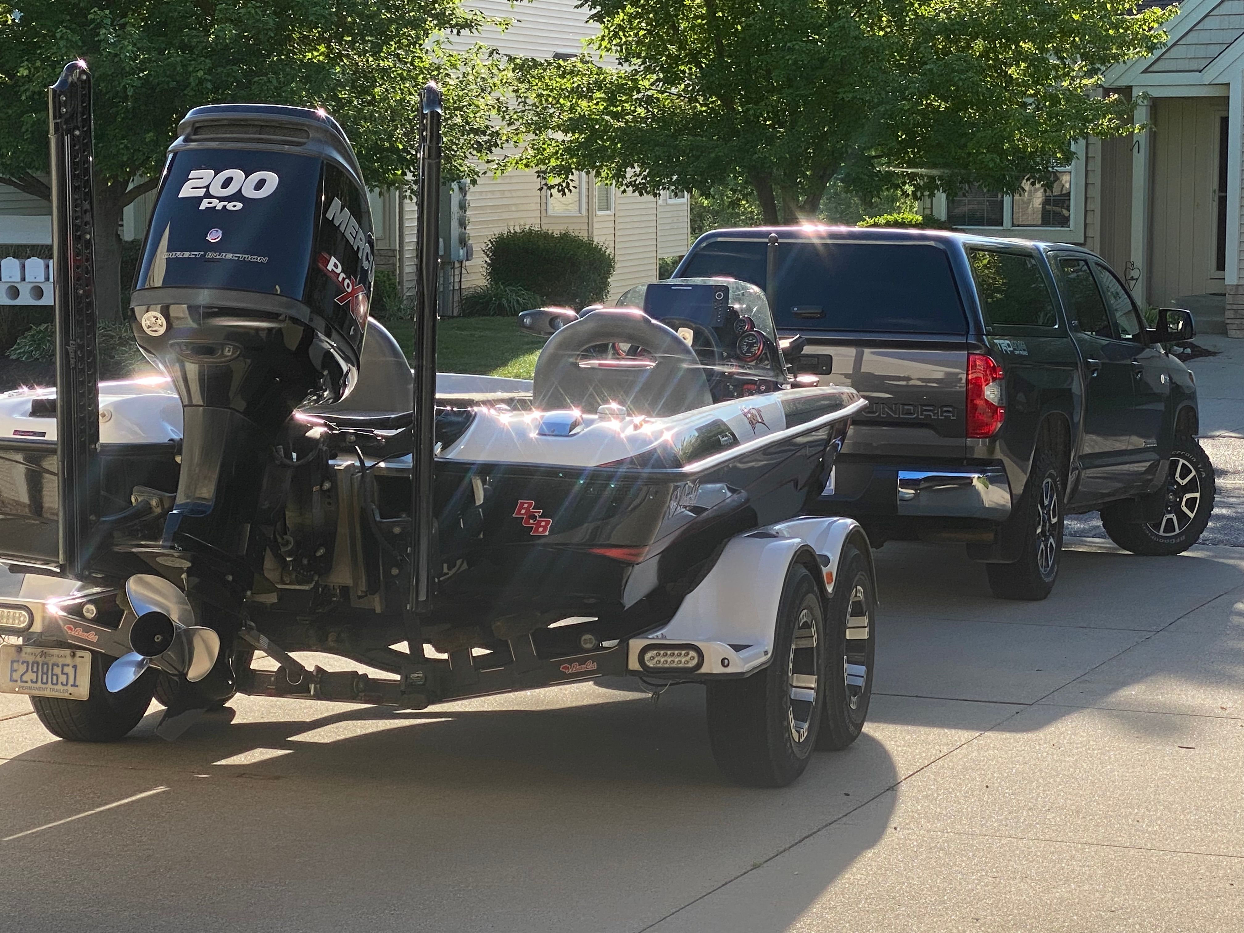 A 2014 Bass Cat Pantera II boat on a trailer, towed by a pickup truck.