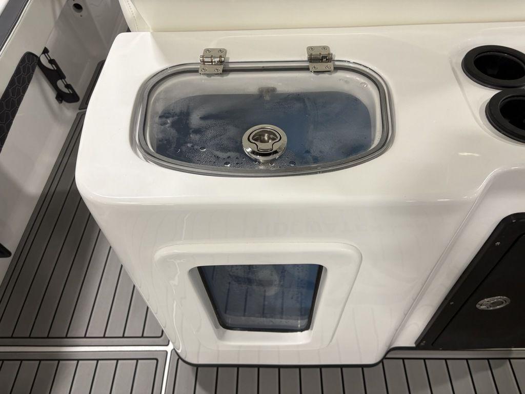 2026 Tidewater 2700 CB boat livewell with transparent lid and cup holders.