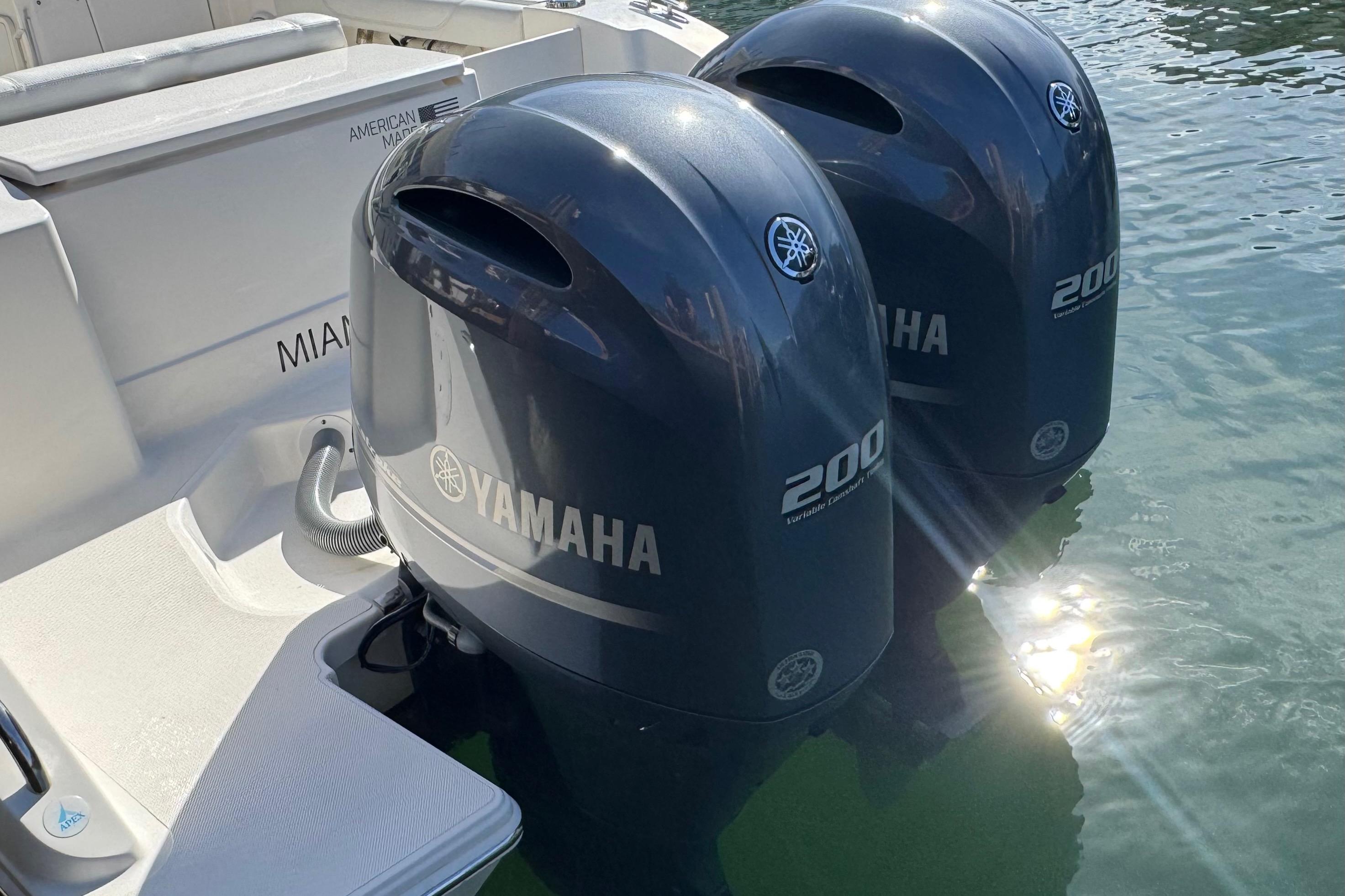 2022 Pursuit DC 266 Dual Console with twin Yamaha 200 engines in water.