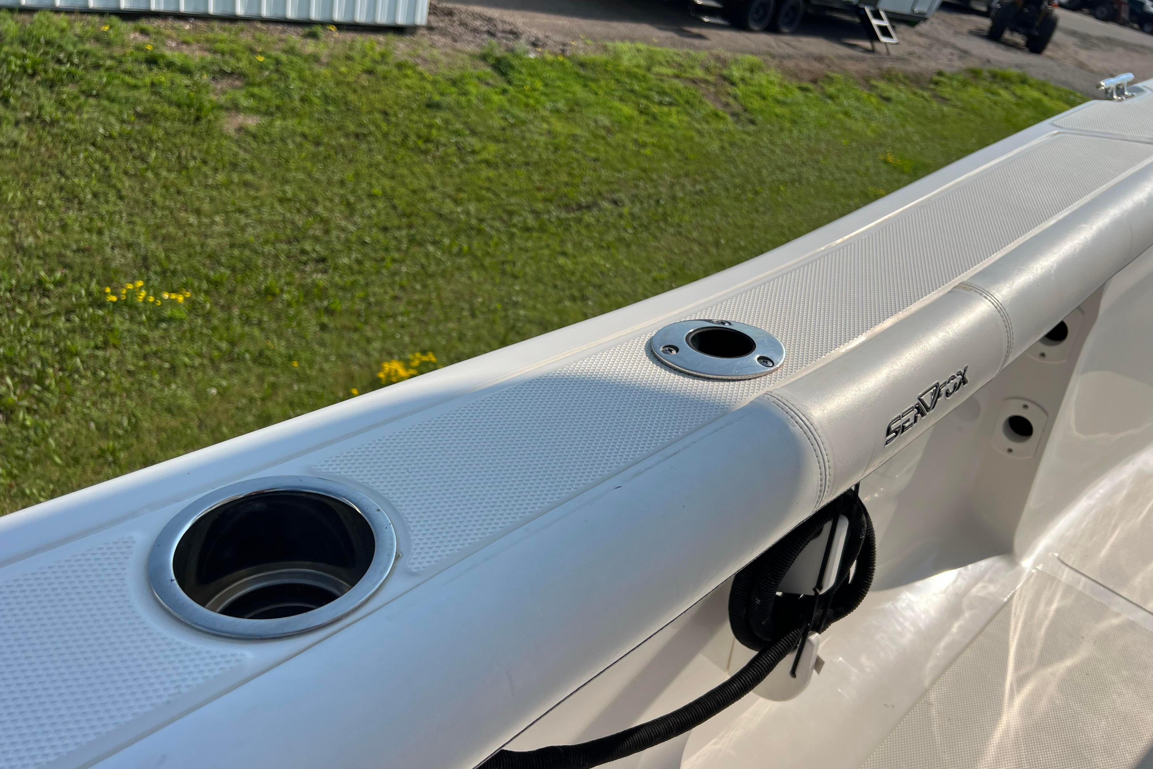 2012 Sea Fox 206 Center Console boat interior with rod holders and logo detail.