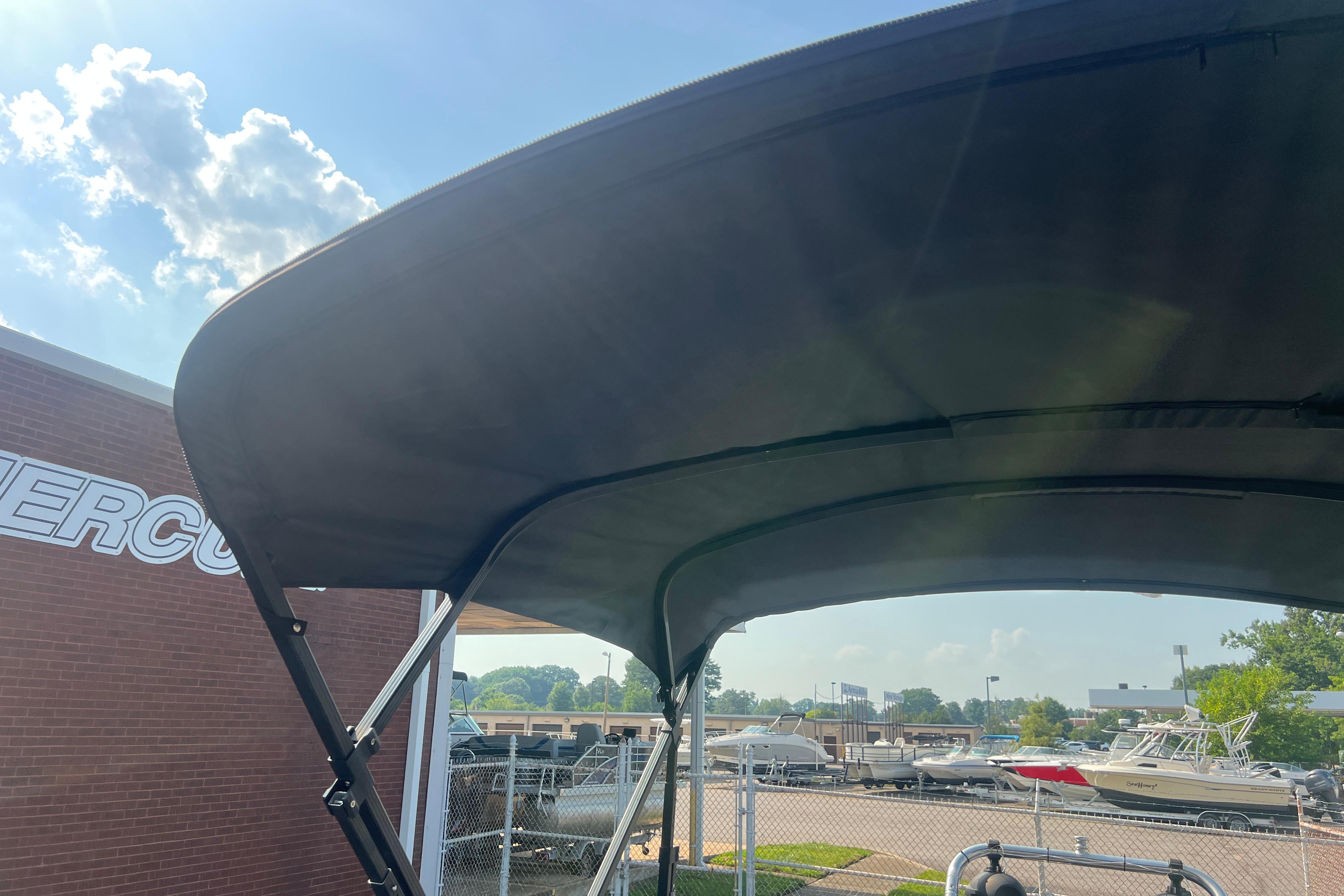 2022 Viaggio Lago V-U 22 boat canopy under sunny sky at dealership.