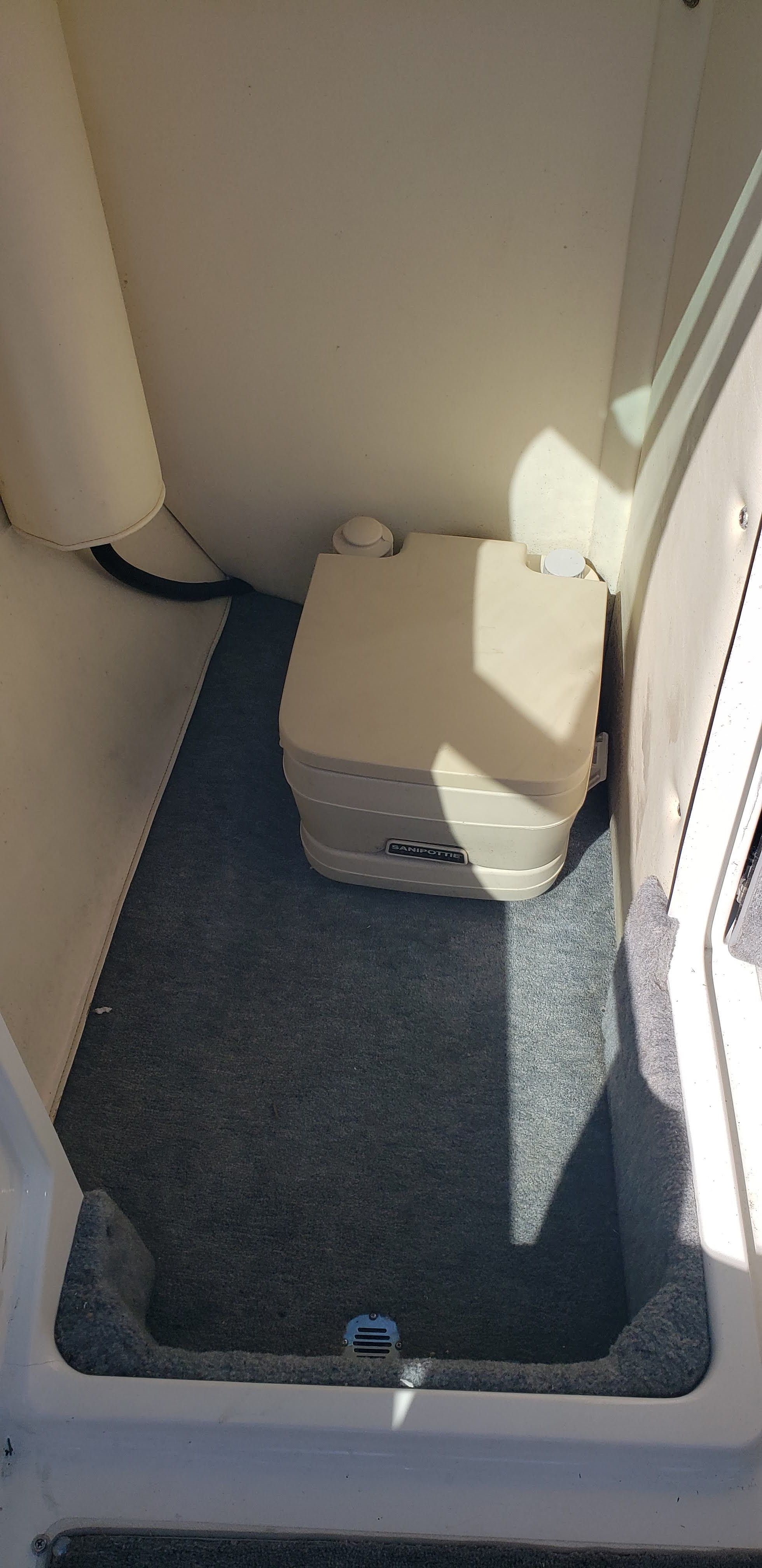 Interior of a 1993 Cobalt 272 with portable toilet.