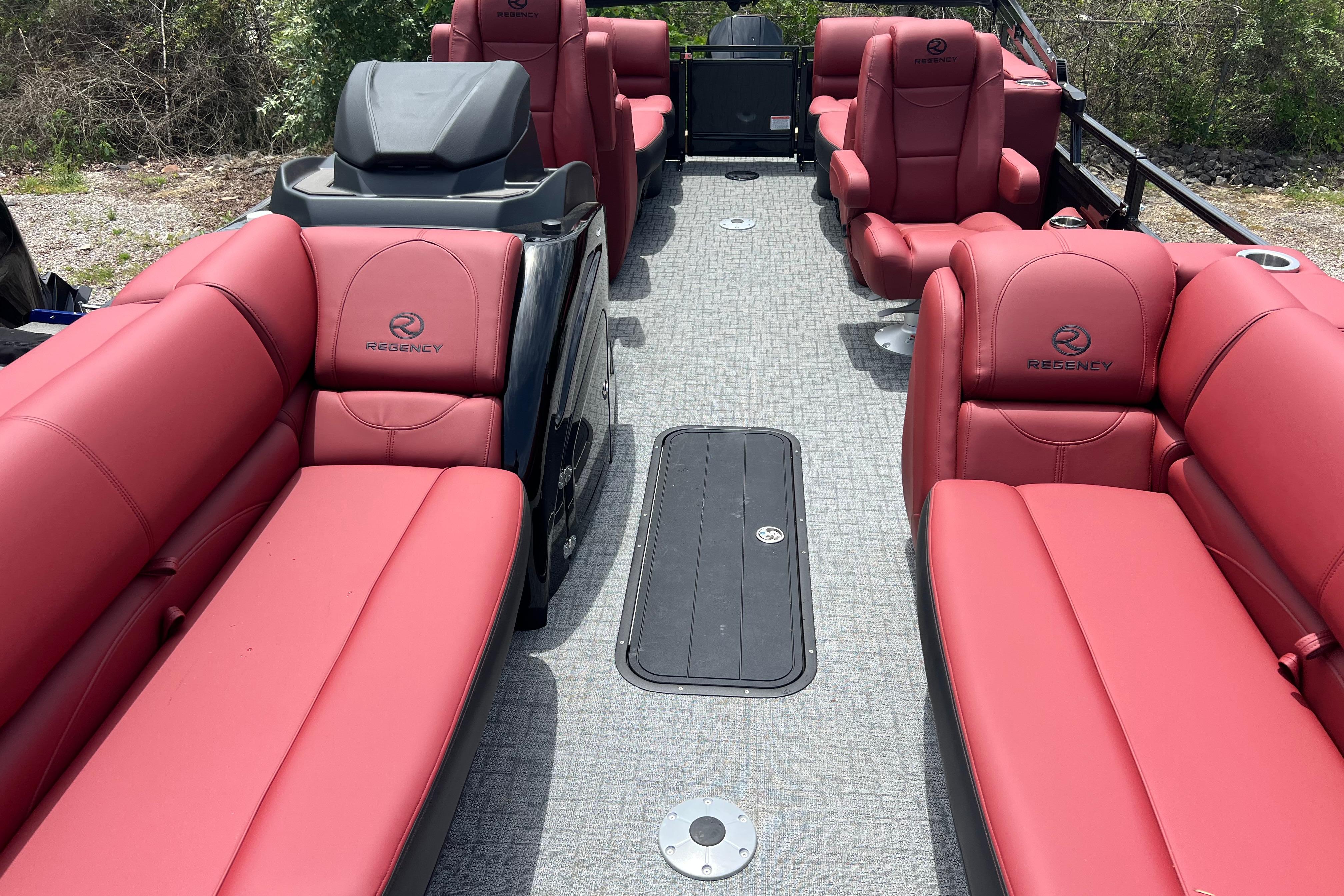 2026 Regency 230 DL pontoon boat with luxurious red seating and spacious deck layout.