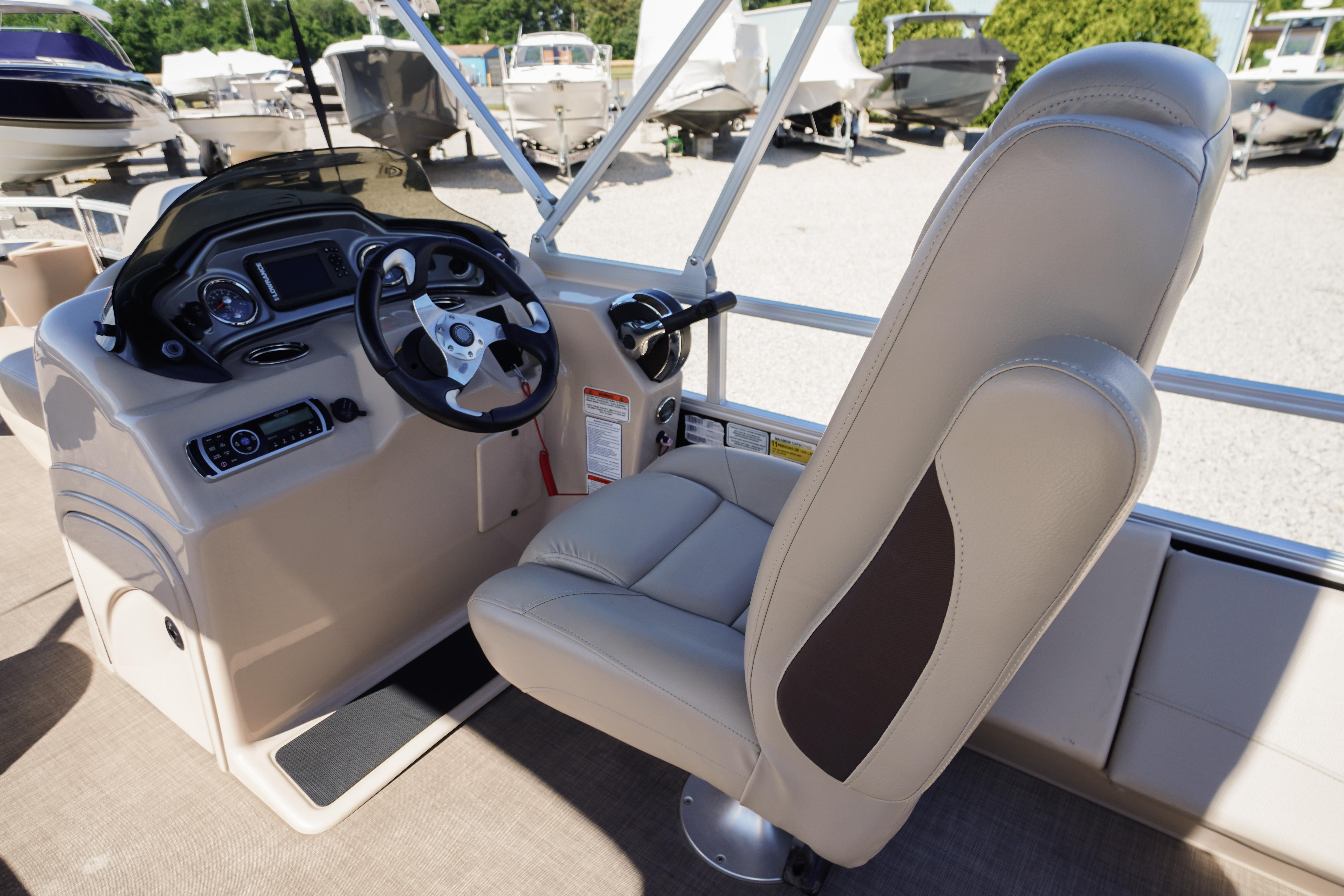 2019 SUNTRACKER Fishin' Barge 22 DLX helm with steering wheel and captain's chair.