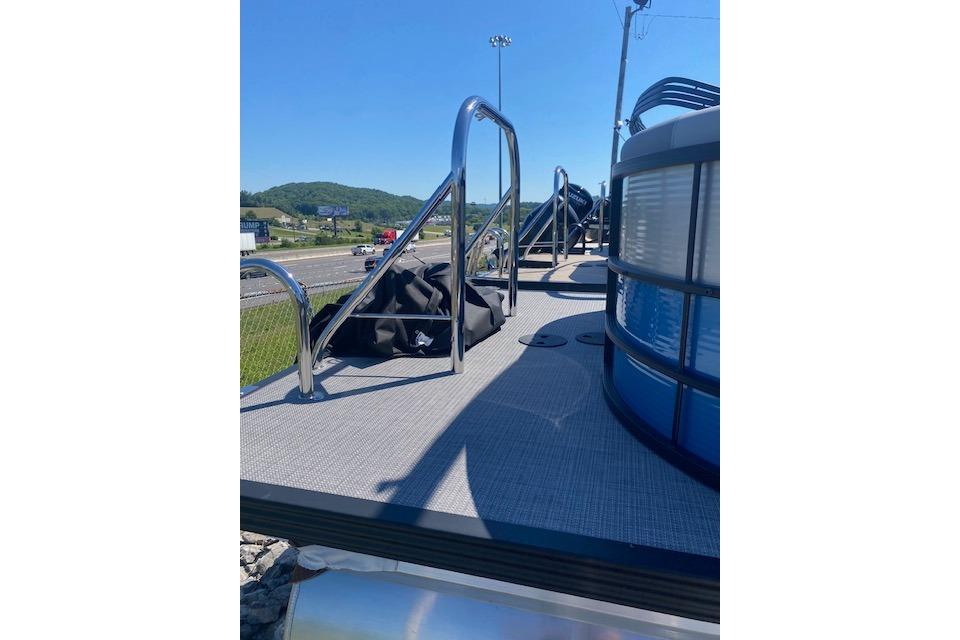 2026 Manitou 23 AURORA RF VPII 575 pontoon boat with sleek railing and deck view.