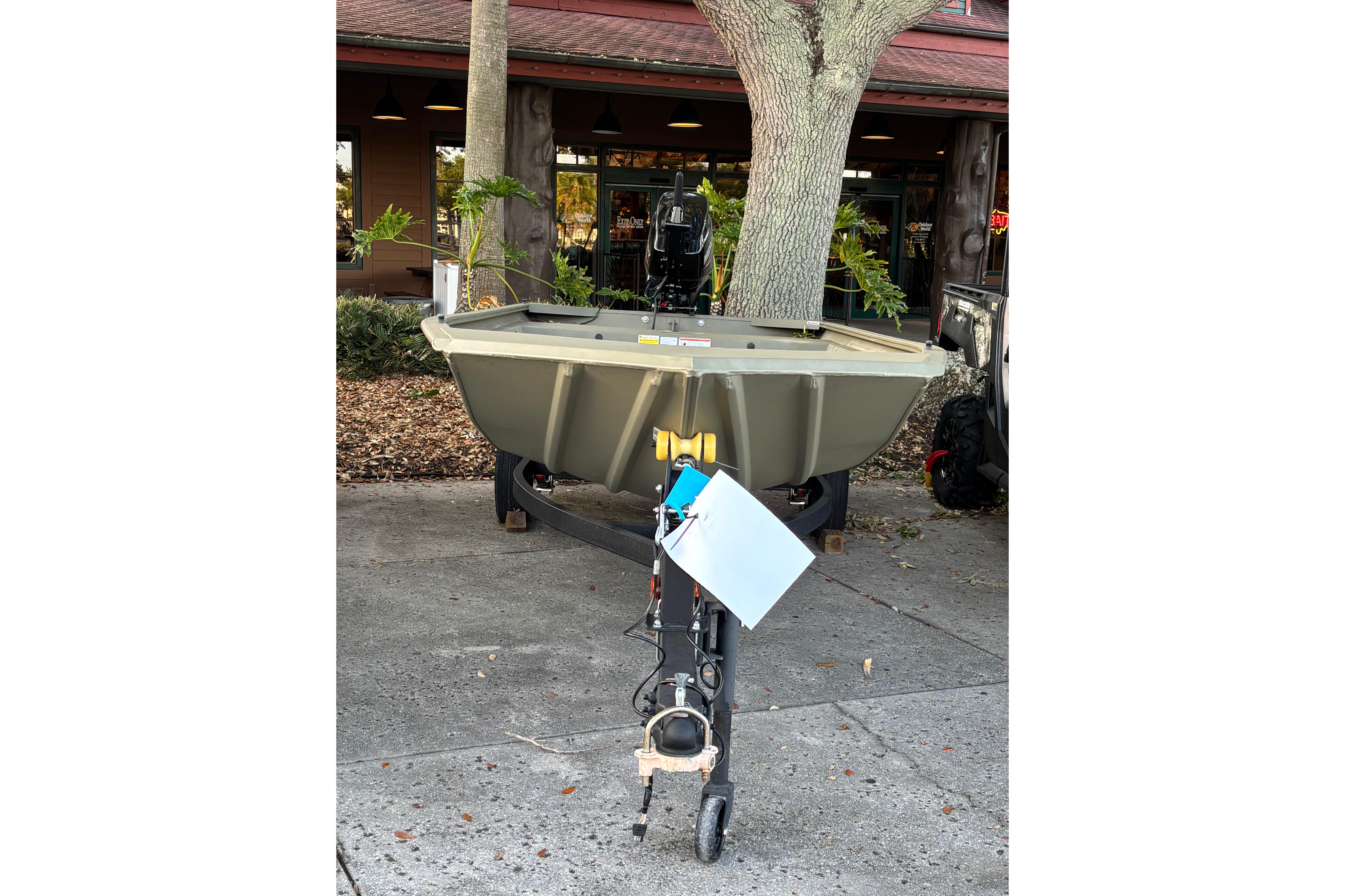 2025 Tracker Grizzly 1648 Jon boat on trailer, parked outdoors.