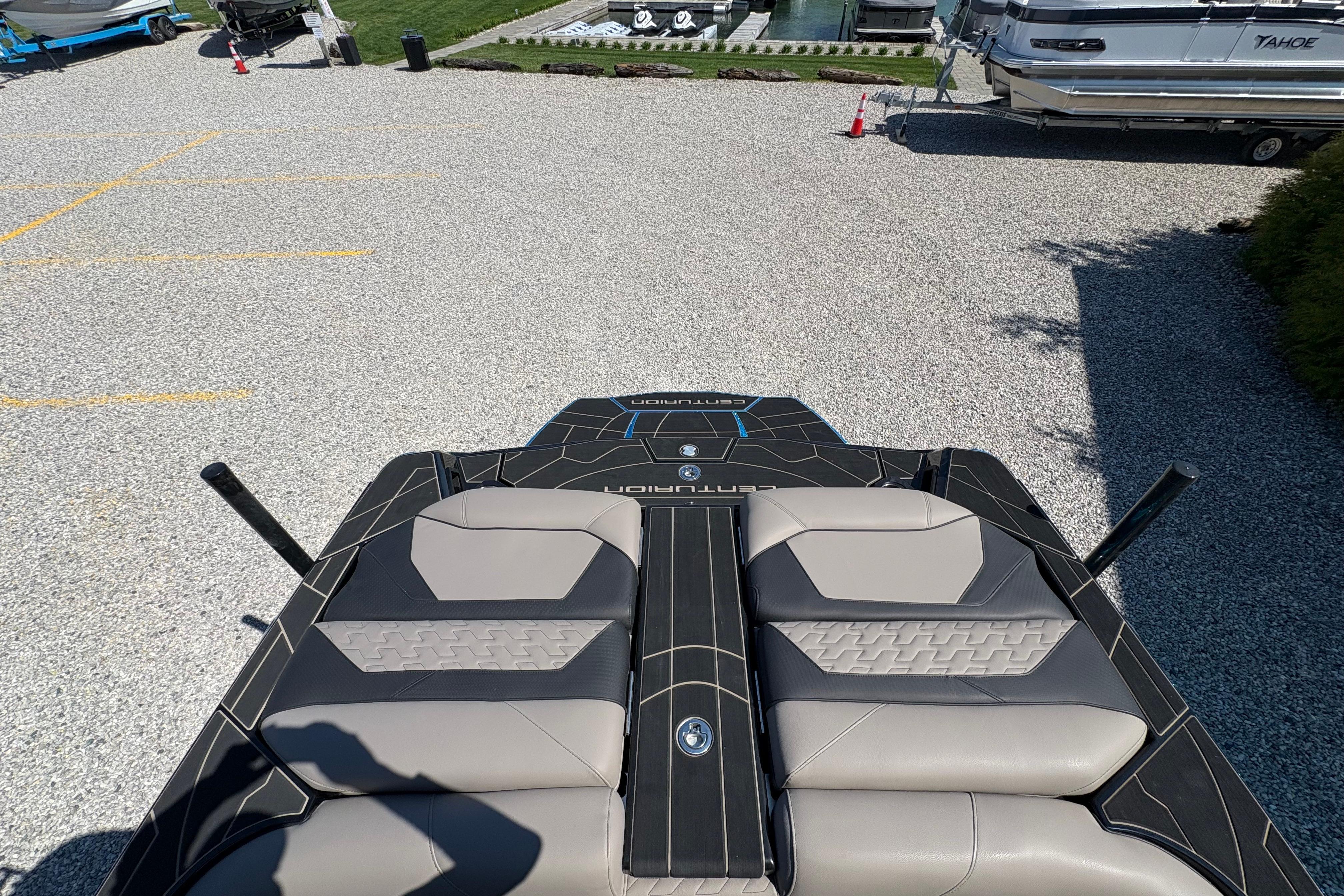 2026 Centurion Ri230 boat with sleek seating and modern design in a marina setting.