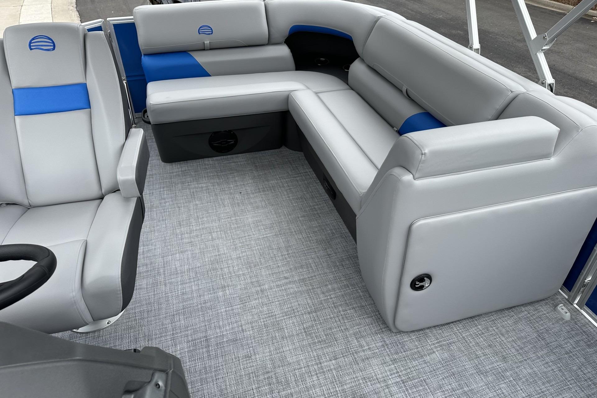 2026 Sun Tracker Party Barge 20 DLX interior with gray and blue seating.