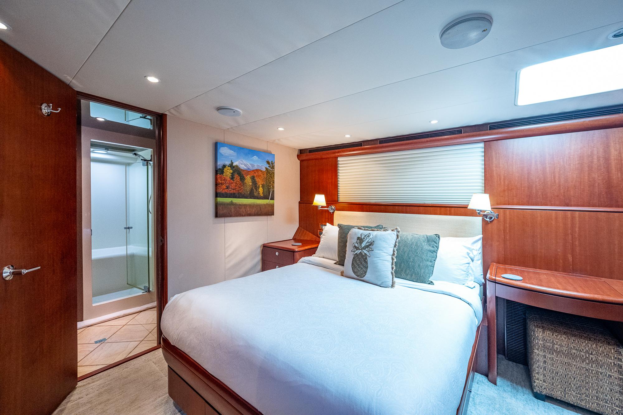 Luxurious bedroom in 2007 Cheoy Lee Bravo Flybridge Motor Yacht with ensuite bathroom.