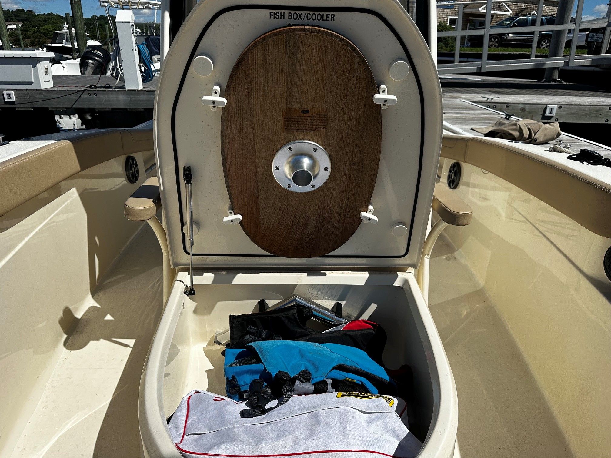 Scout 210XSF 2022 with open fish box cooler and gear.