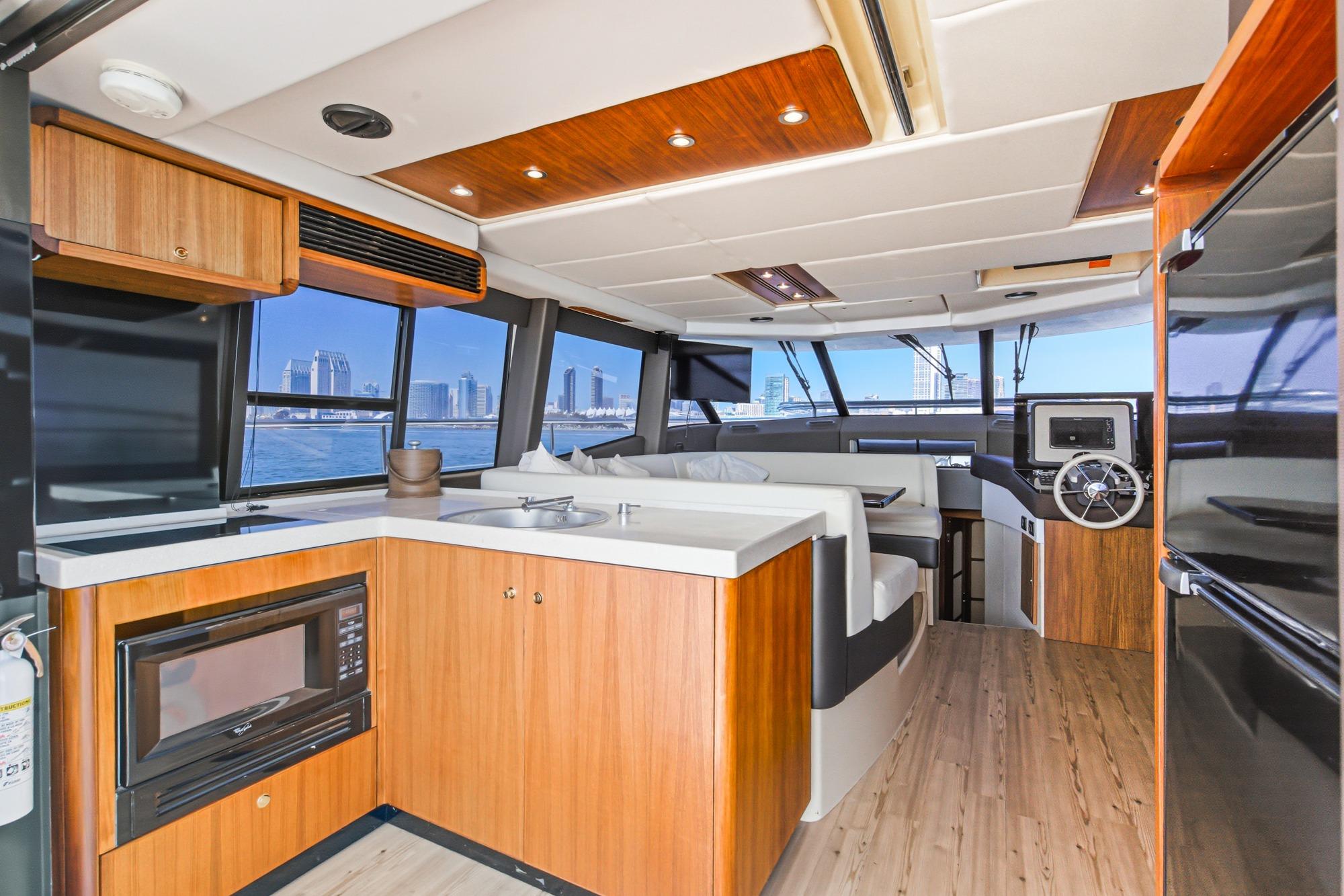 Luxurious interior of 2013 Azimut Magellano 50 yacht with modern kitchen and seating area.