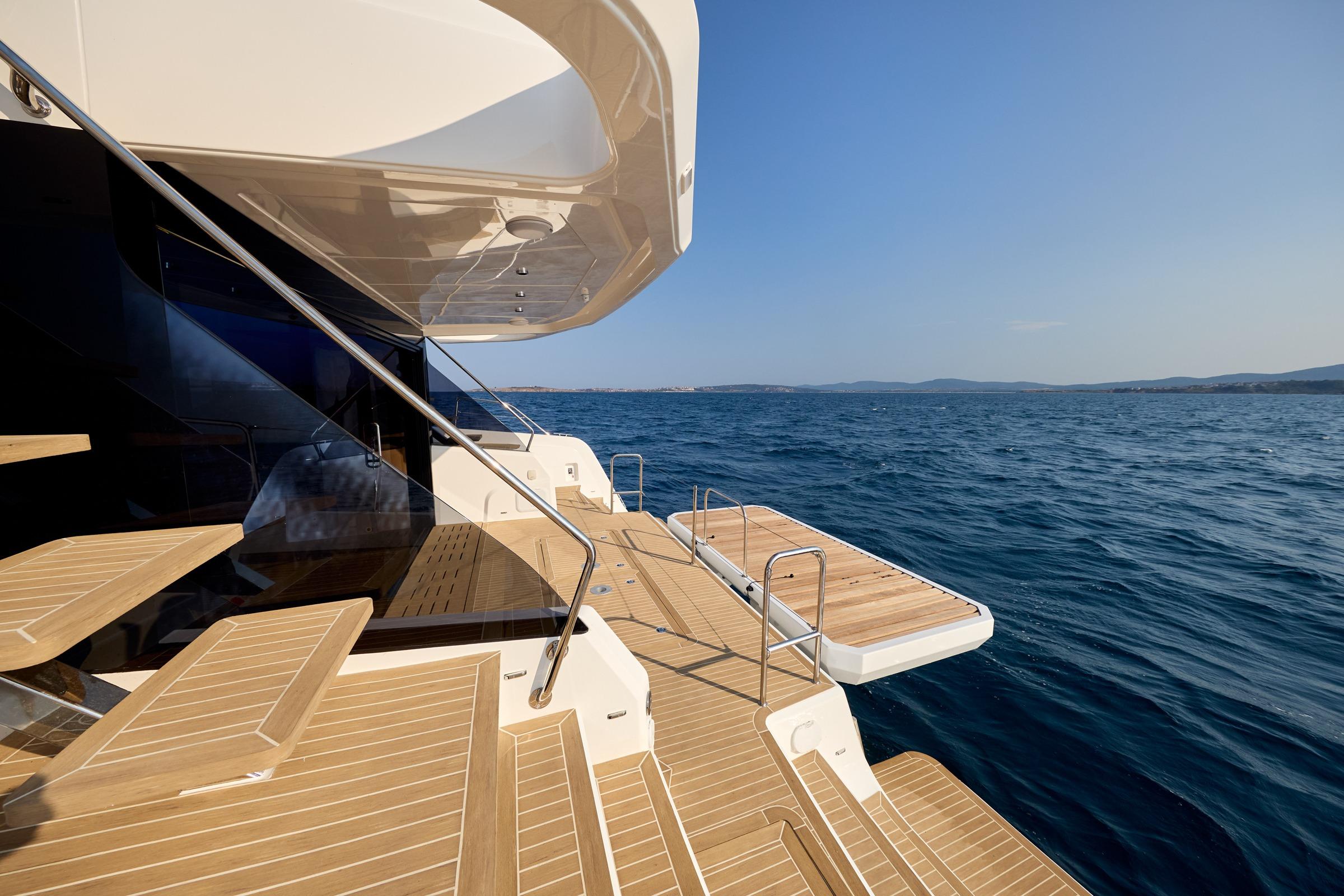 2025 Custom Omaya 50 Power Catamaran with teak deck, ocean view.