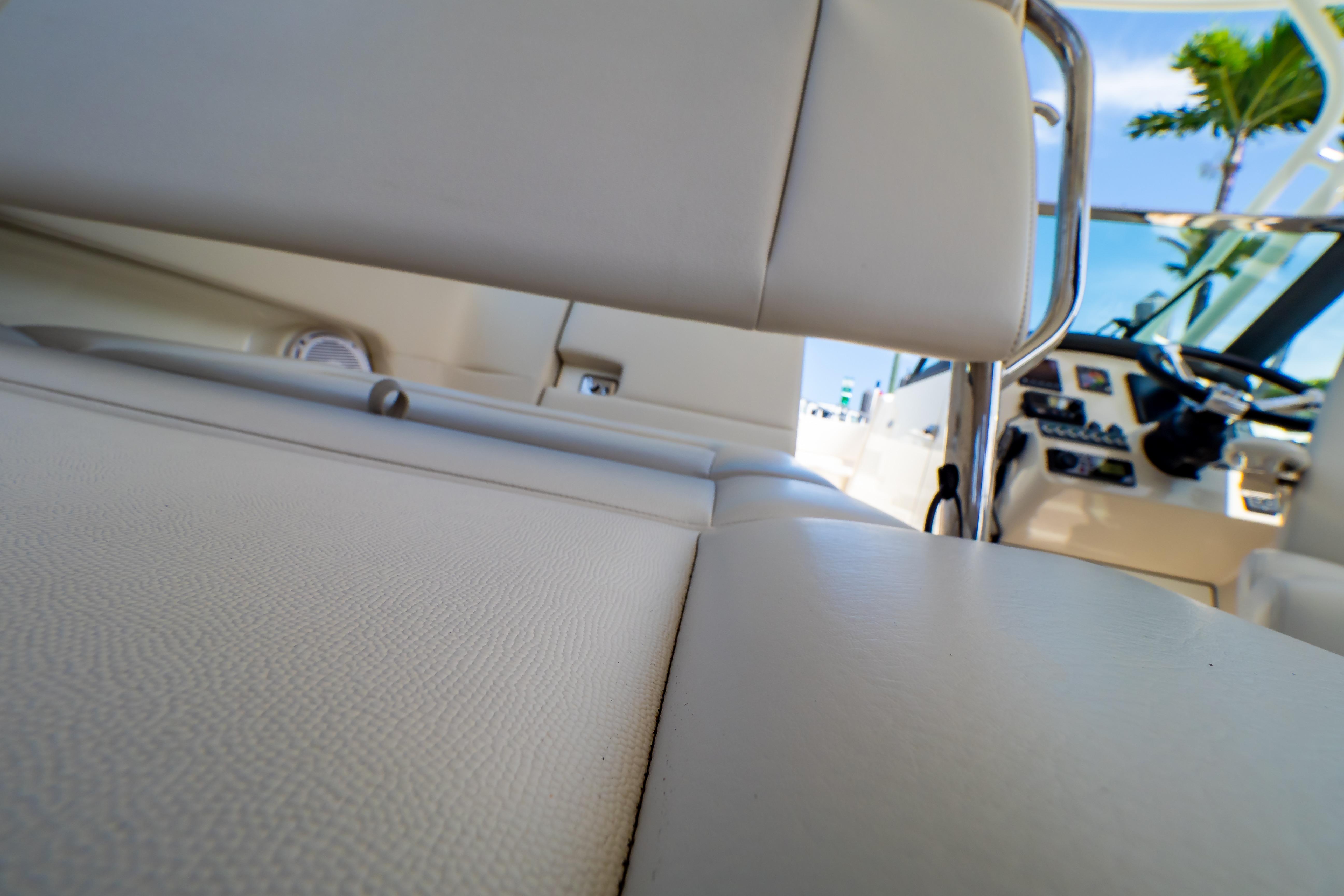 Interior view of 2019 Boston Whaler 270 Vantage boat, featuring seating and control panel.