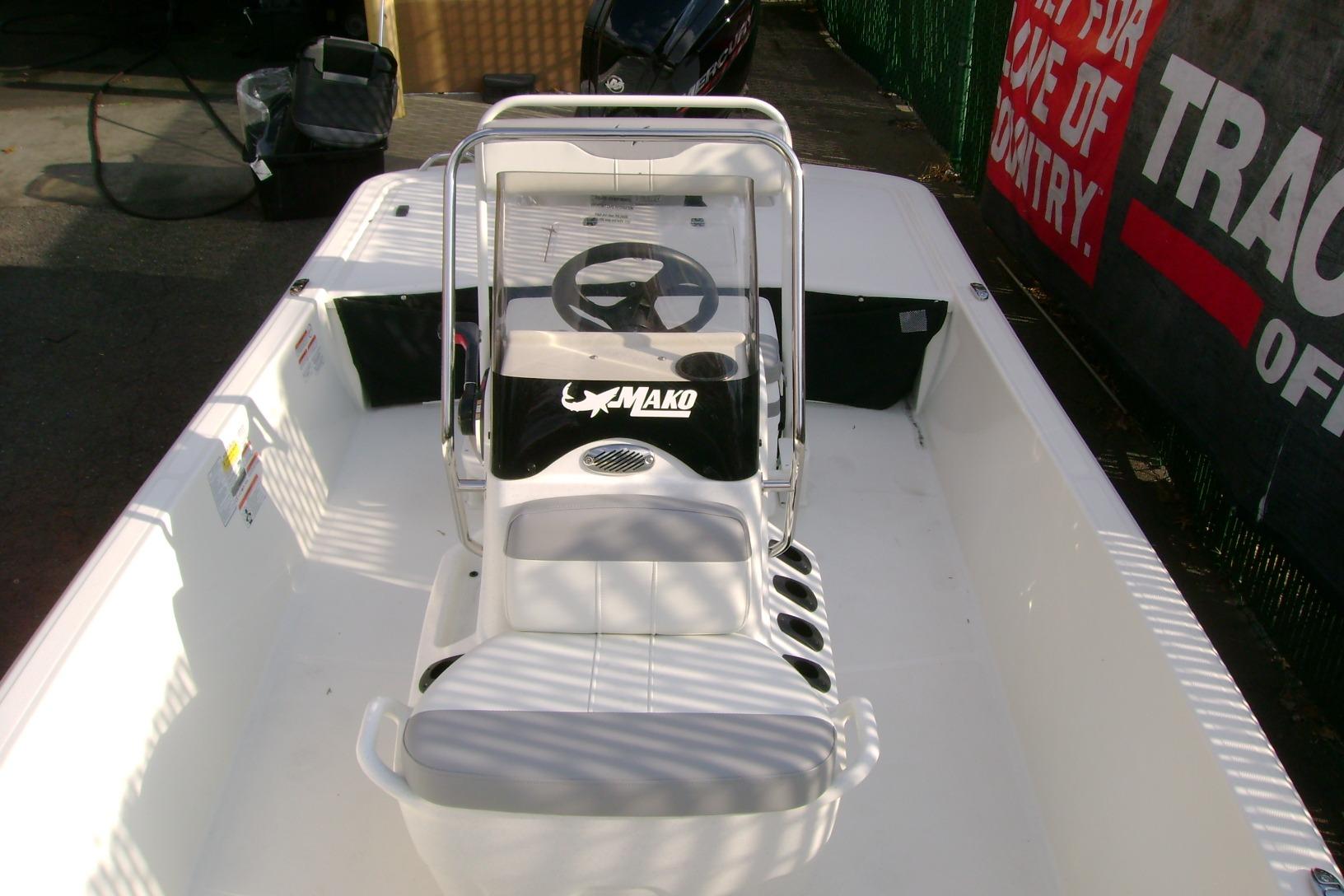 2026 Mako Pro Skiff 17 CC boat interior with steering console and seating.