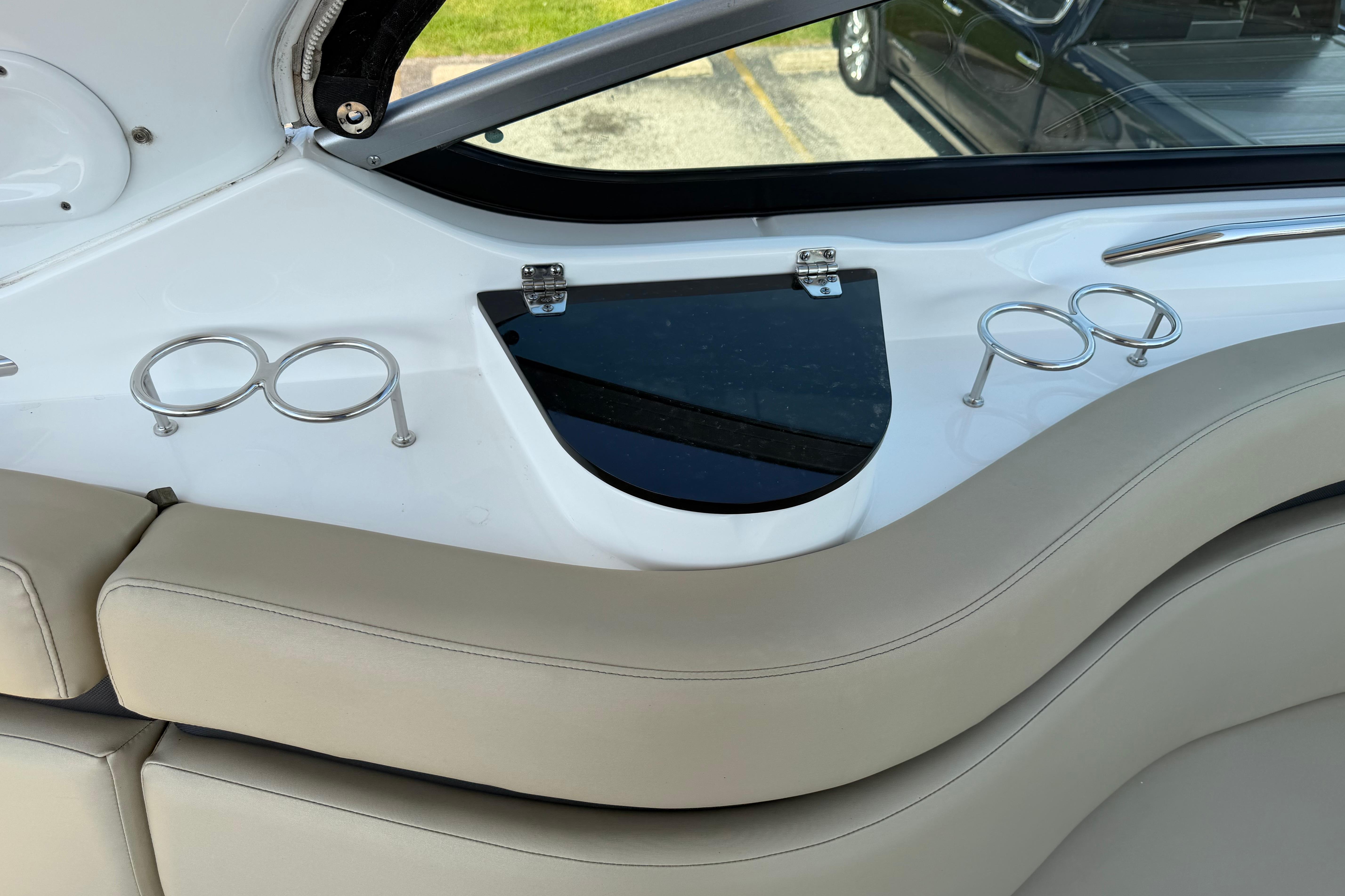 Interior of 2019 Rinker EX 320 boat with cup holders and seating.