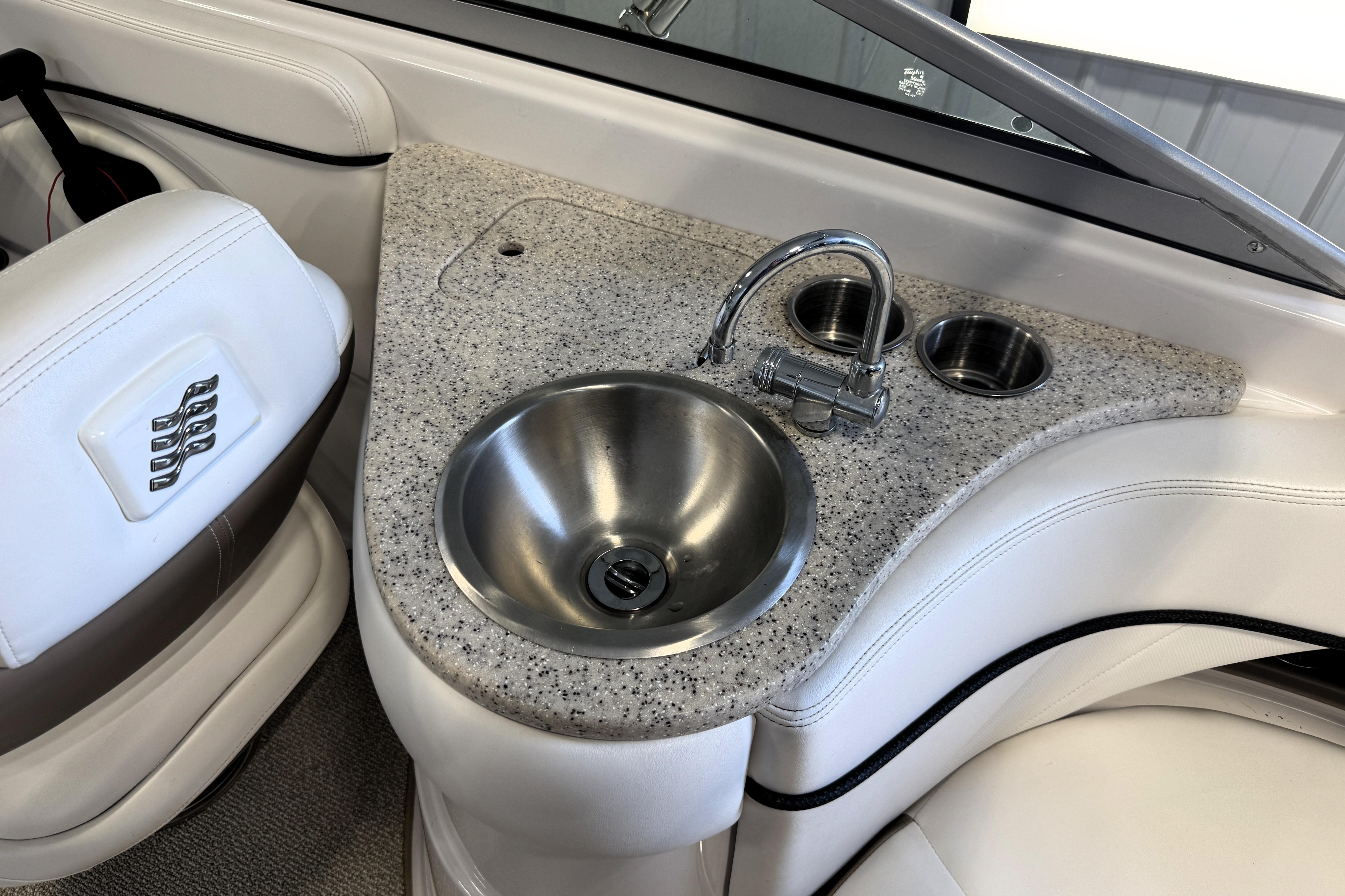 2008 Four Winns H240 boat interior with sink and cup holders.