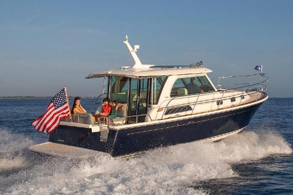 A 2027 Sabre 38 Salon Express cruising on water with an American flag at the stern.
