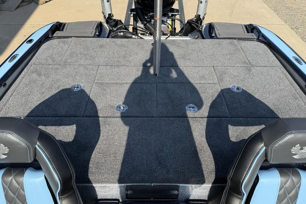 2026 Phoenix 20 XE boat interior with gray carpet and black leather seats.