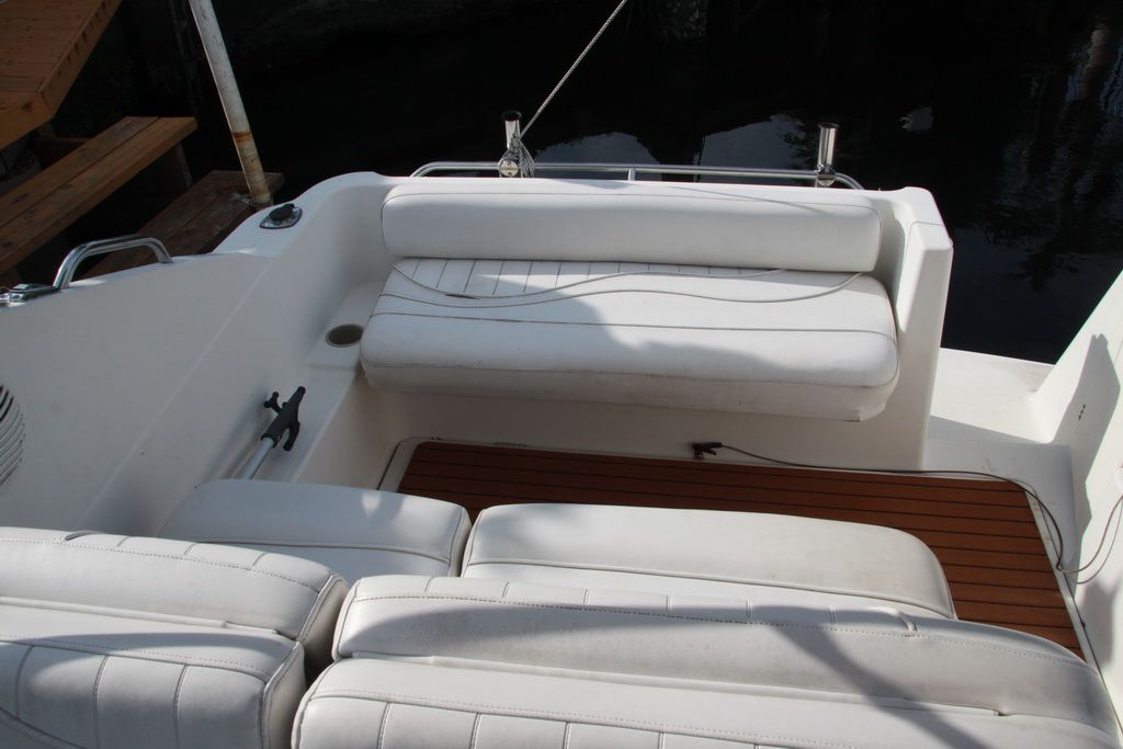 Interior of a 1999 Maxum 2400 Mercruiser boat with white seating.