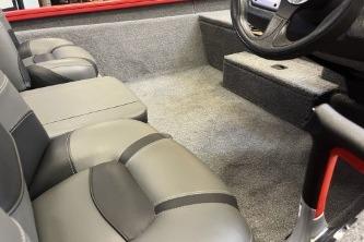 2026 Tracker Pro Team 175 boat interior with gray seating and steering wheel.