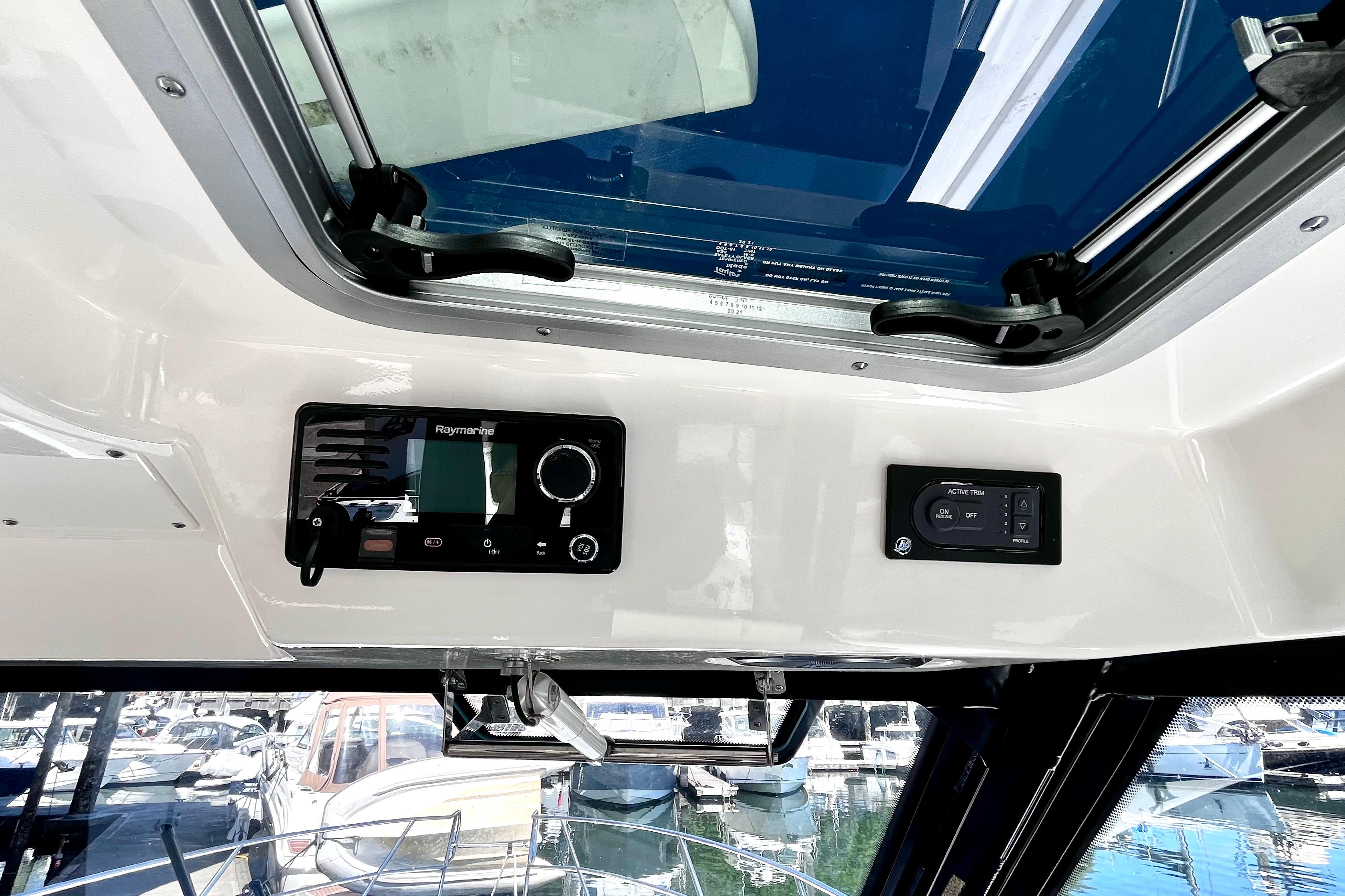 Interior view of 2026 Boston Whaler 325 Conquest Pilothouse with navigation controls.