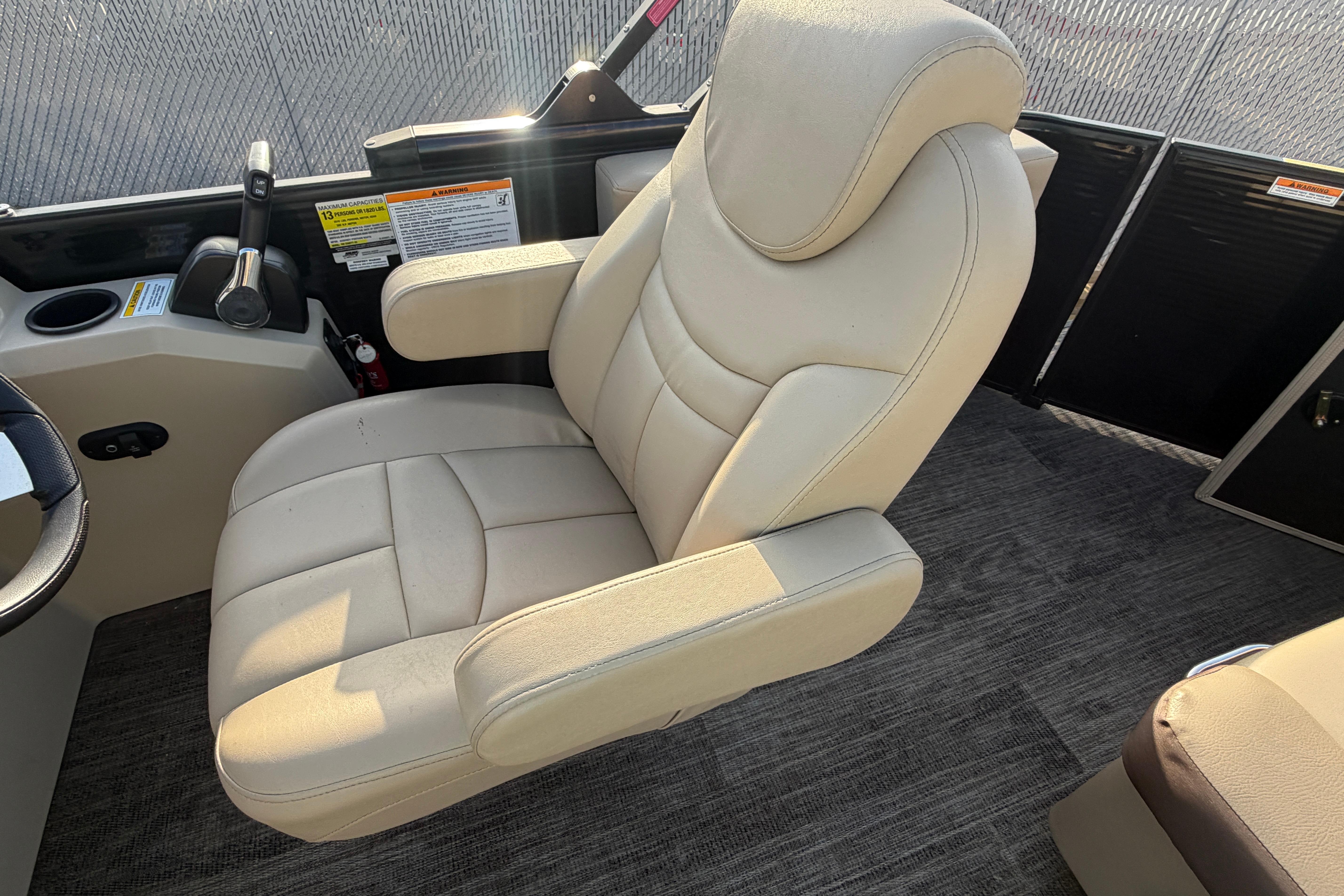 Luxurious captain's chair on 2023 Godfrey Sweetwater 2286 C pontoon boat.