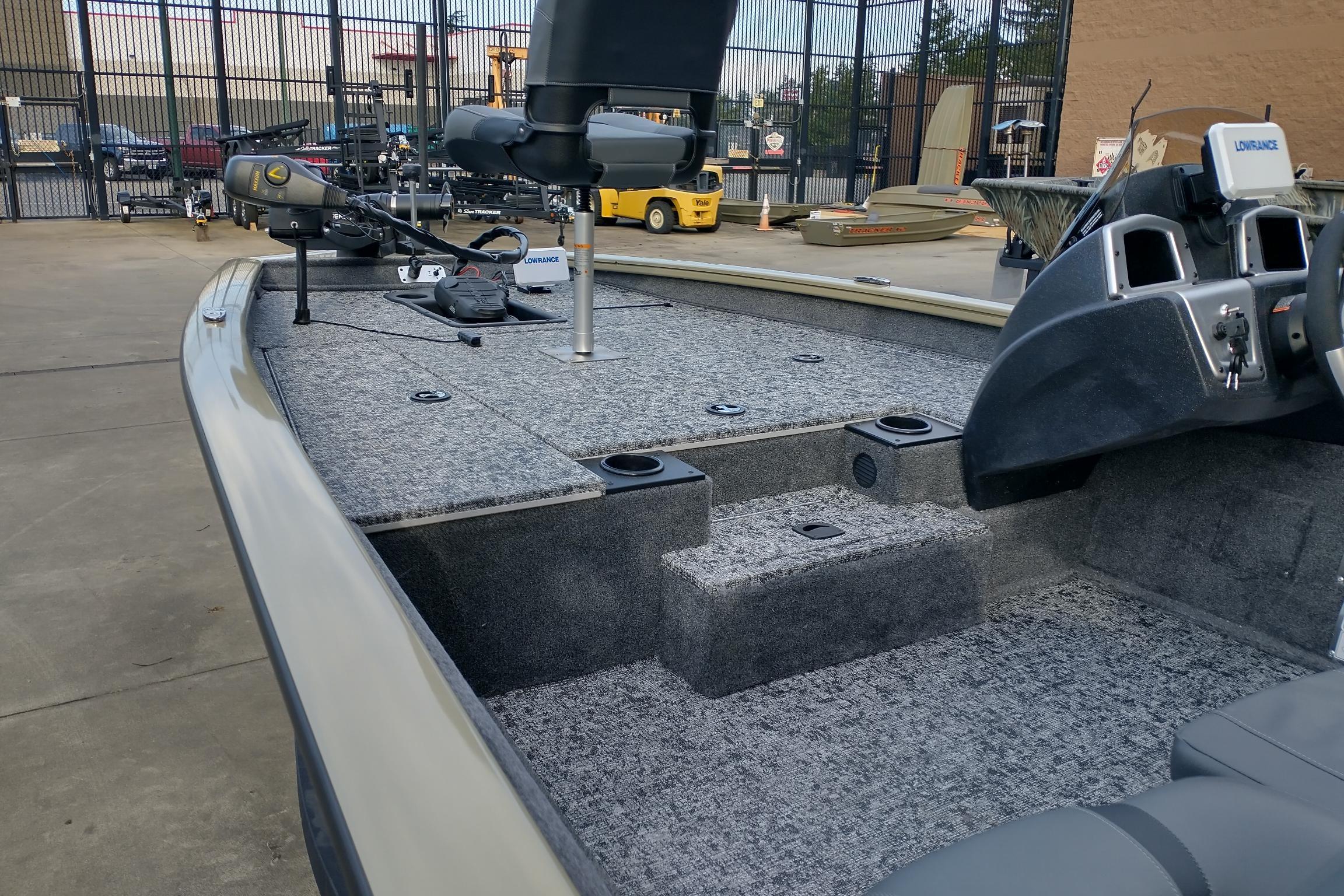 2026 Tracker Pro Team 175 boat interior with carpeted deck and fishing equipment.