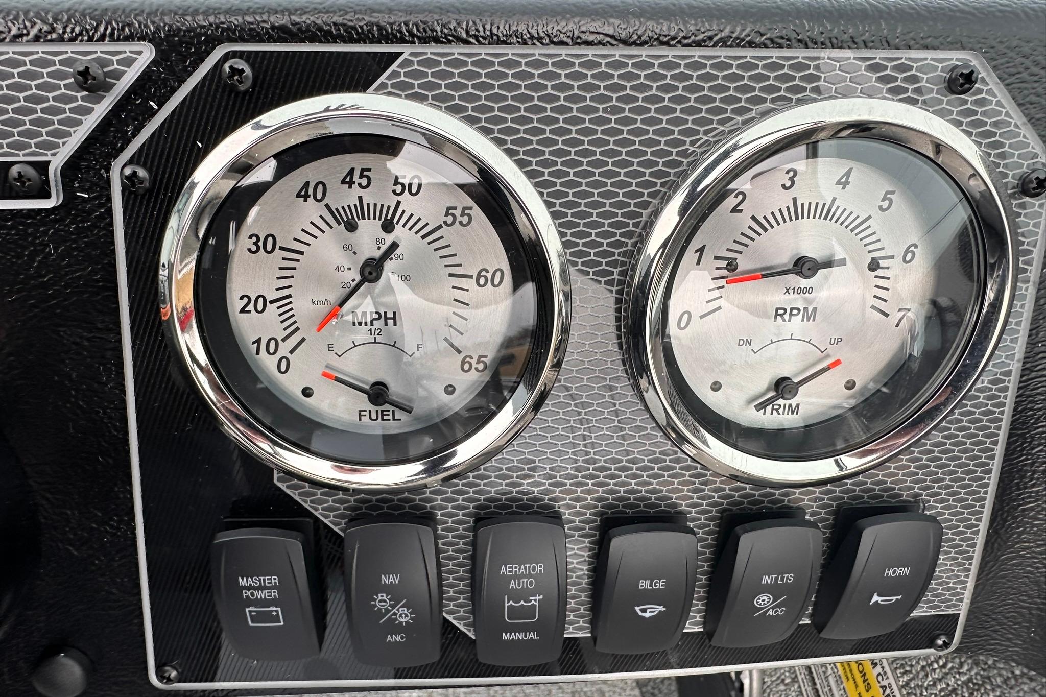 Dashboard of 2026 Lund 1775 Adventure Sport with speedometer, tachometer, and control switches.