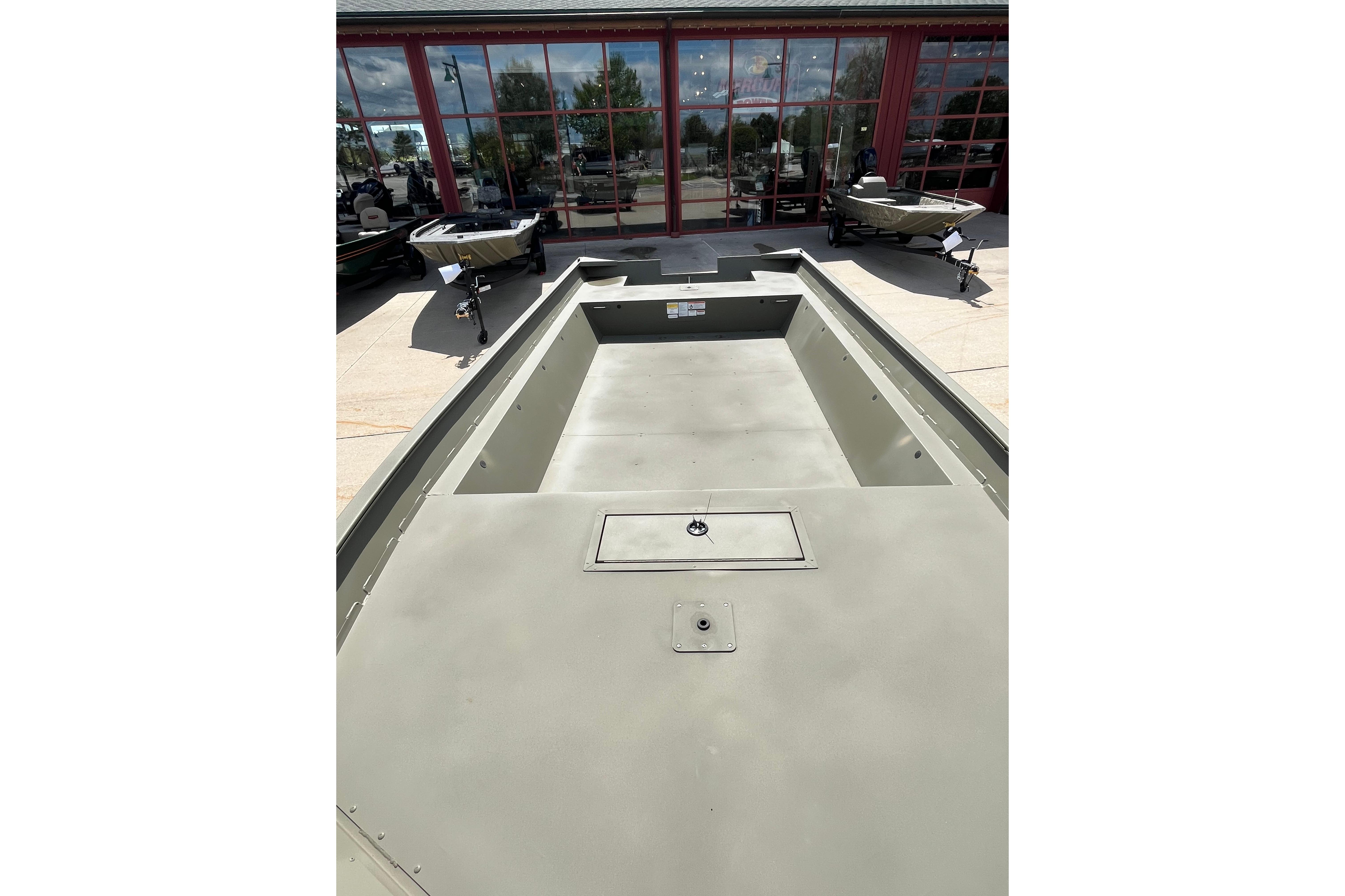 2026 Tracker Grizzly 2072 Utility boat, spacious interior, parked outside showroom.