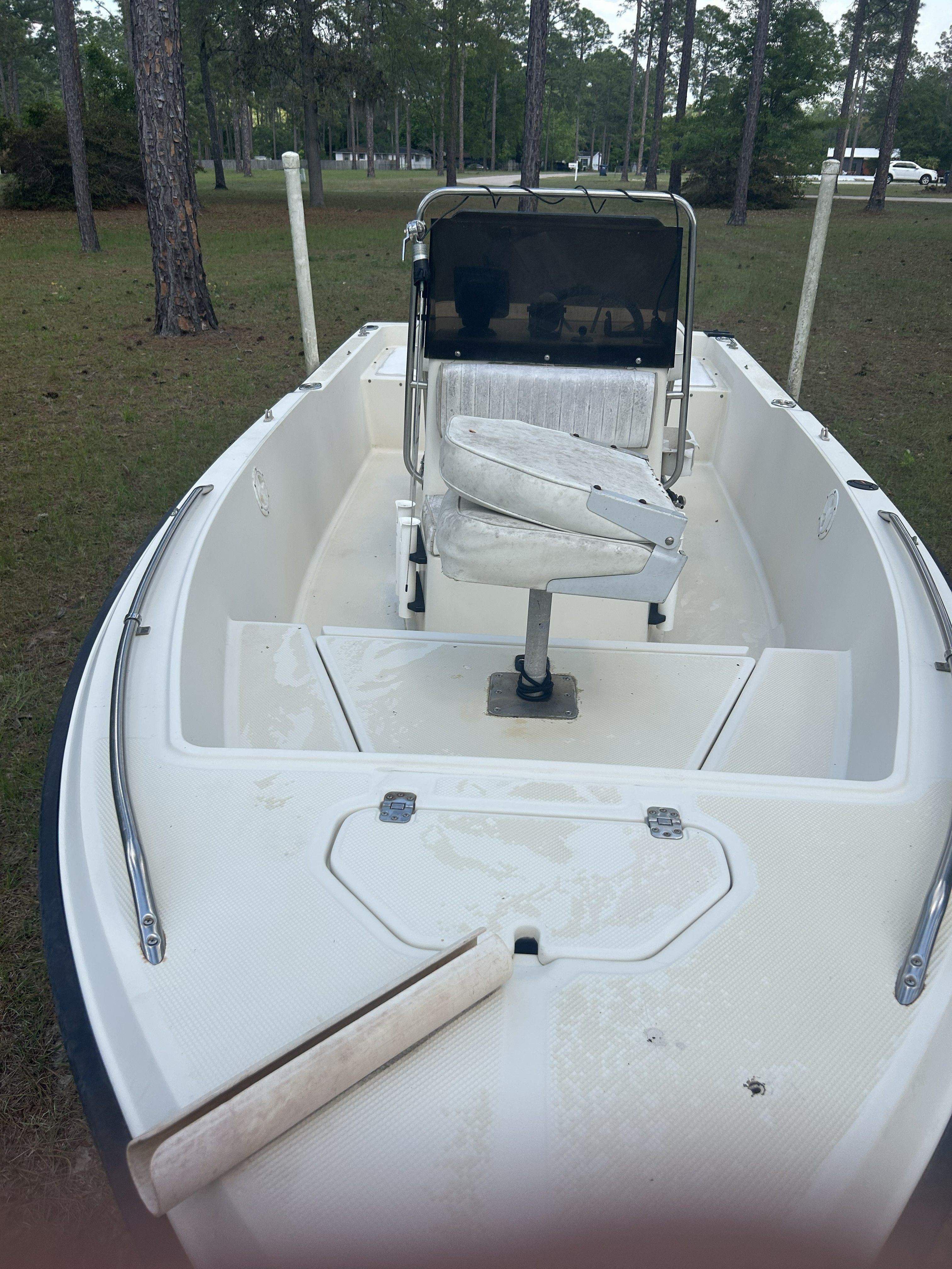 1993 Key West 1720 boat parked on grass, interior view.