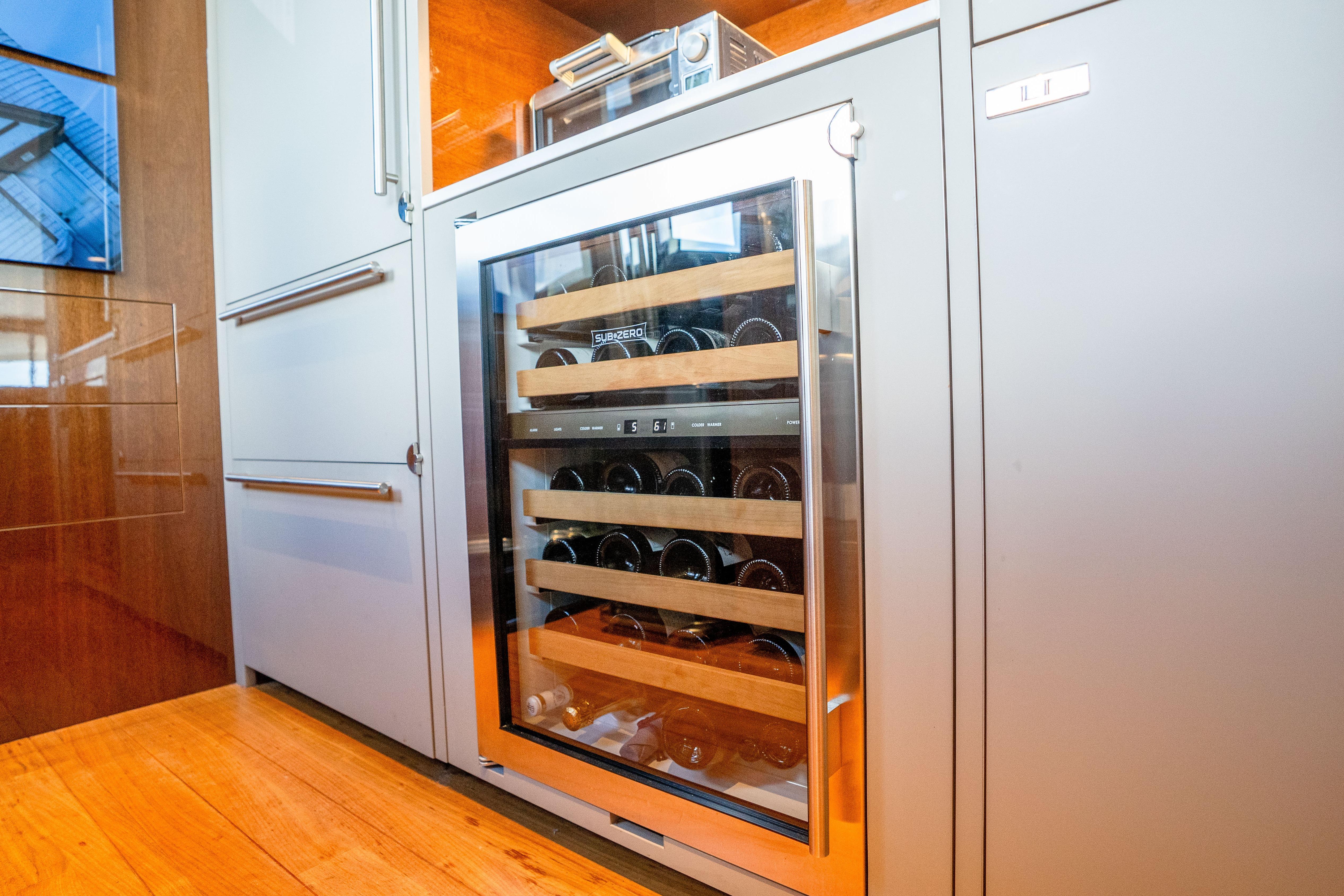 Modern kitchen with Sub-Zero wine cooler on Princess Y85 yacht, 2020 model.