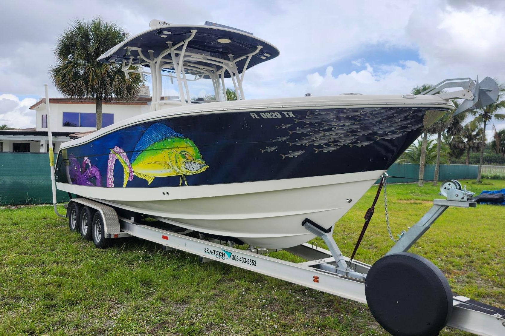 2015 Robalo R300 Center Console boat with vibrant marine artwork on trailer.