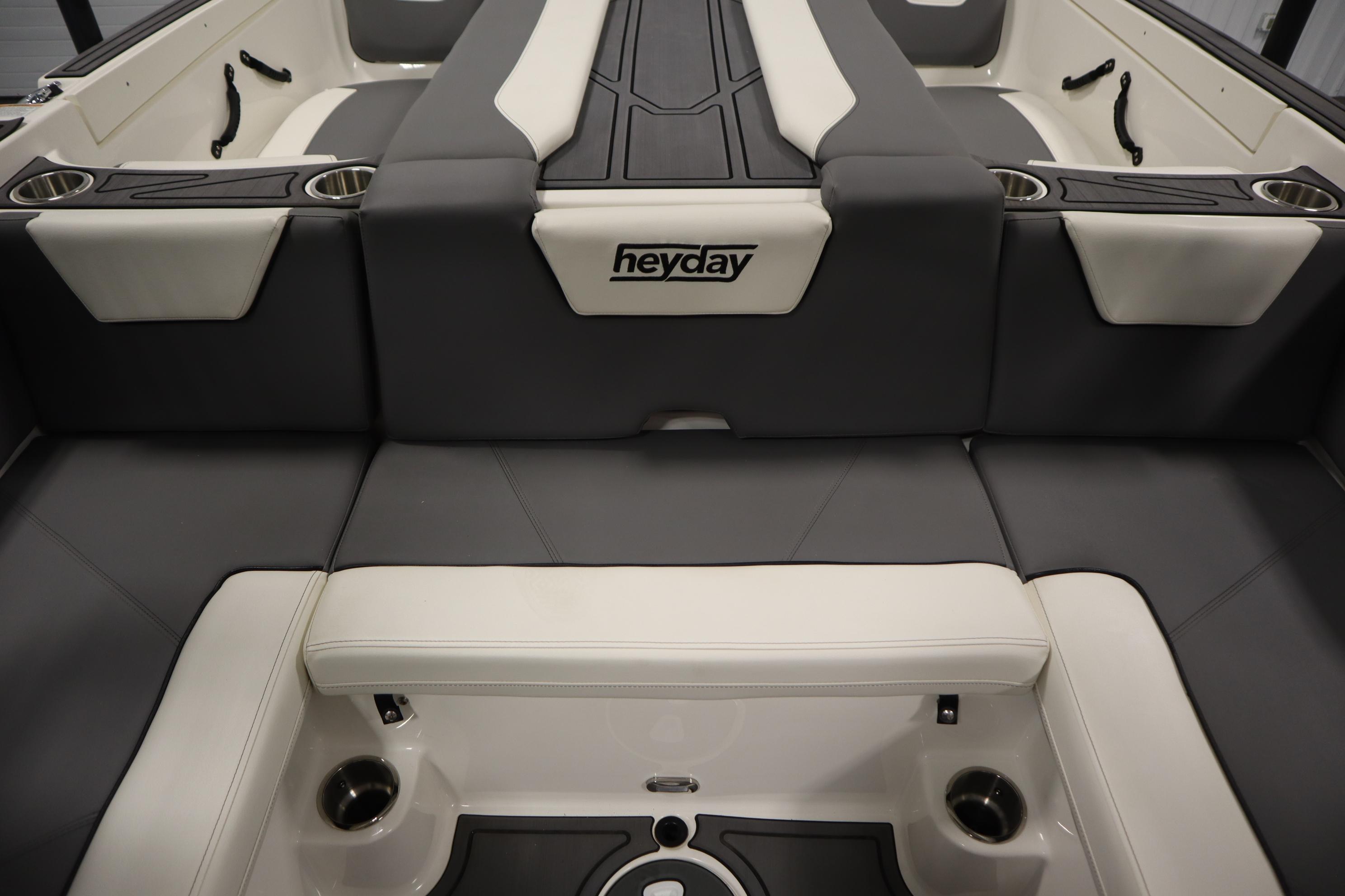 2023 Heyday WT Surf boat interior with gray and white seating and cup holders.