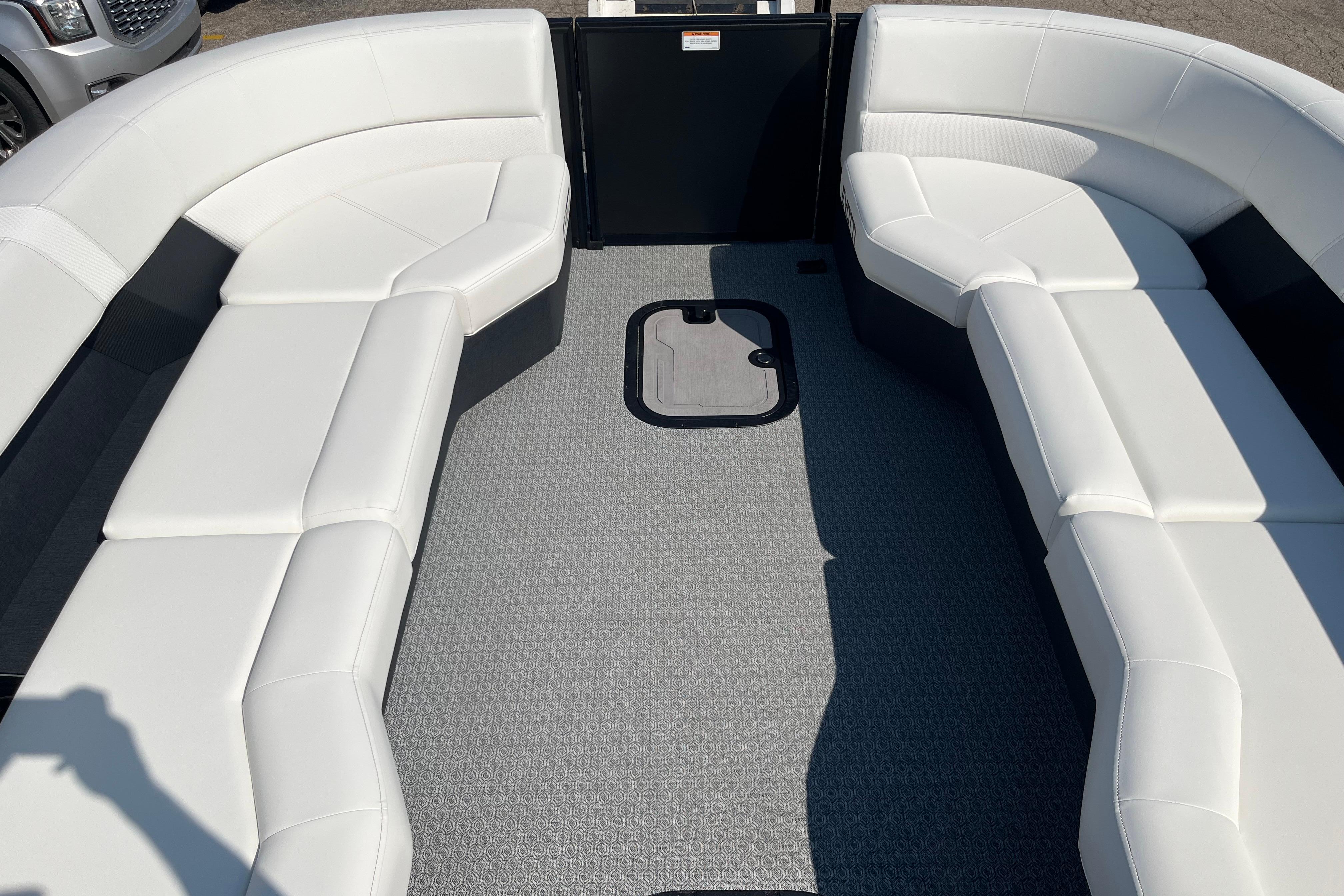 Interior of 2026 Evotti 725CS boat with white seating and gray flooring.